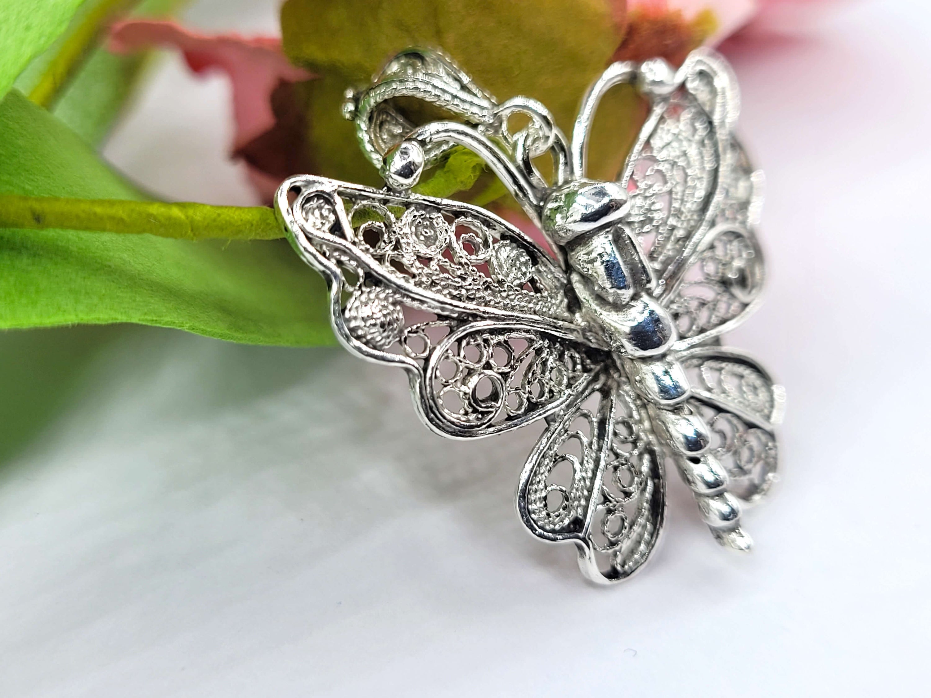 Sterling silver butterfly pendant necklace featuring intricate filigree design, displayed on a white background.