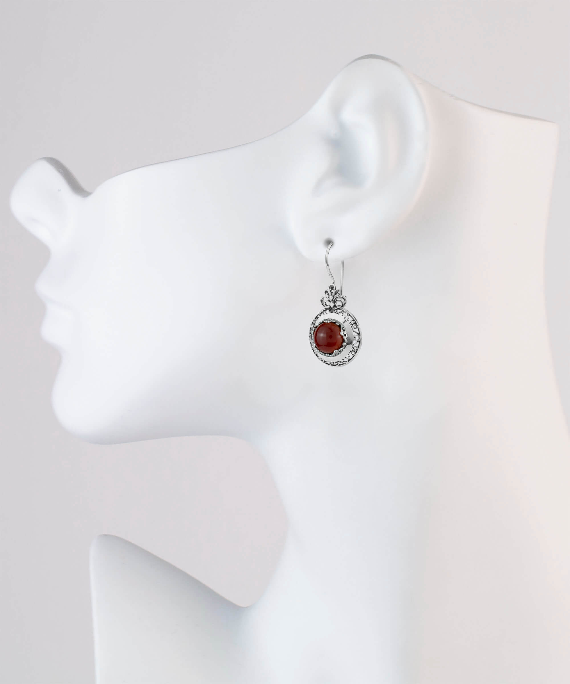 Handmade silver drop earrings featuring intricate filigree floral design and warm Carnelian gemstones, elegantly displayed in a luxurious gift box.