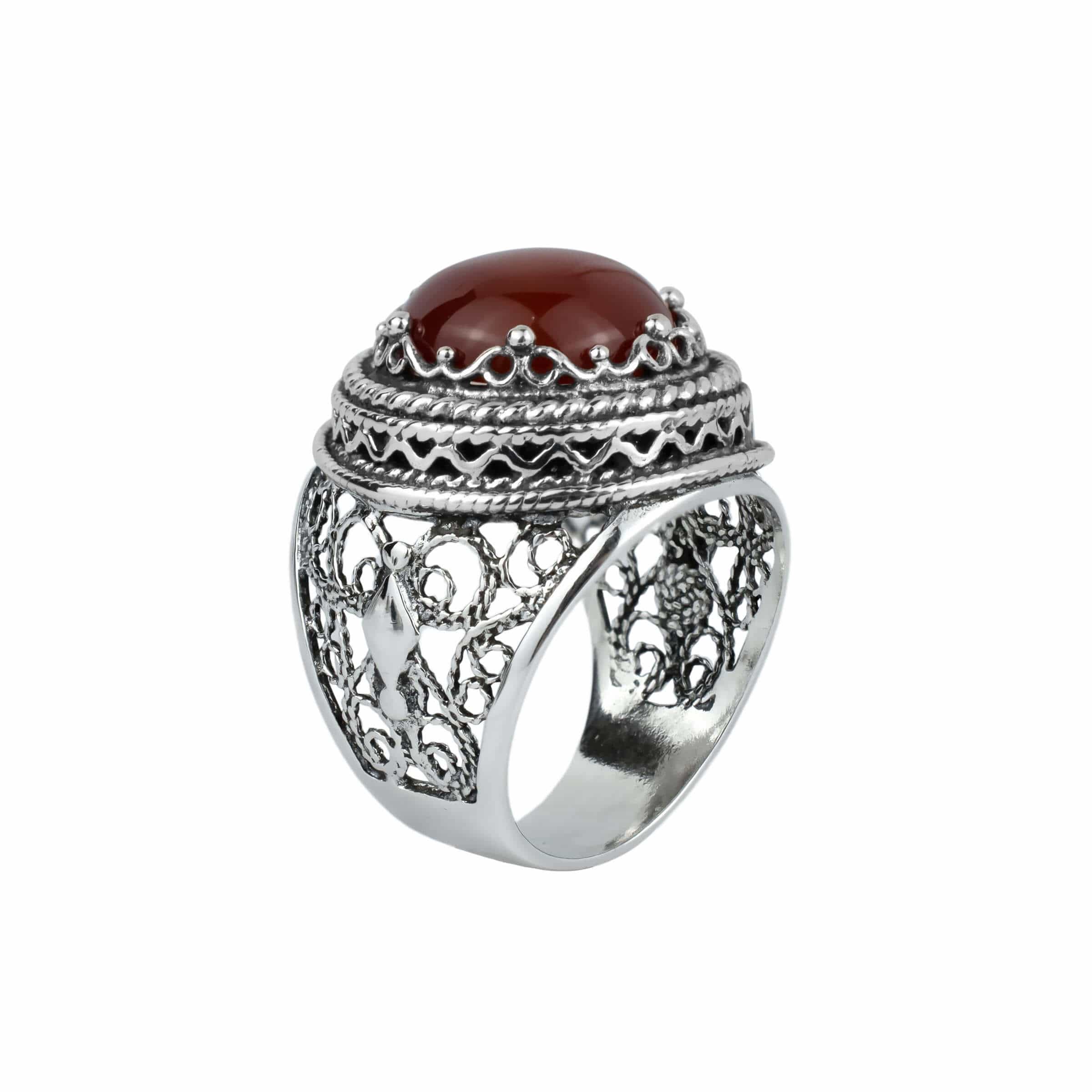 A stunning sterling silver bold ring featuring a round-cut 12mm carnelian gemstone, showcasing intricate filigree art design.