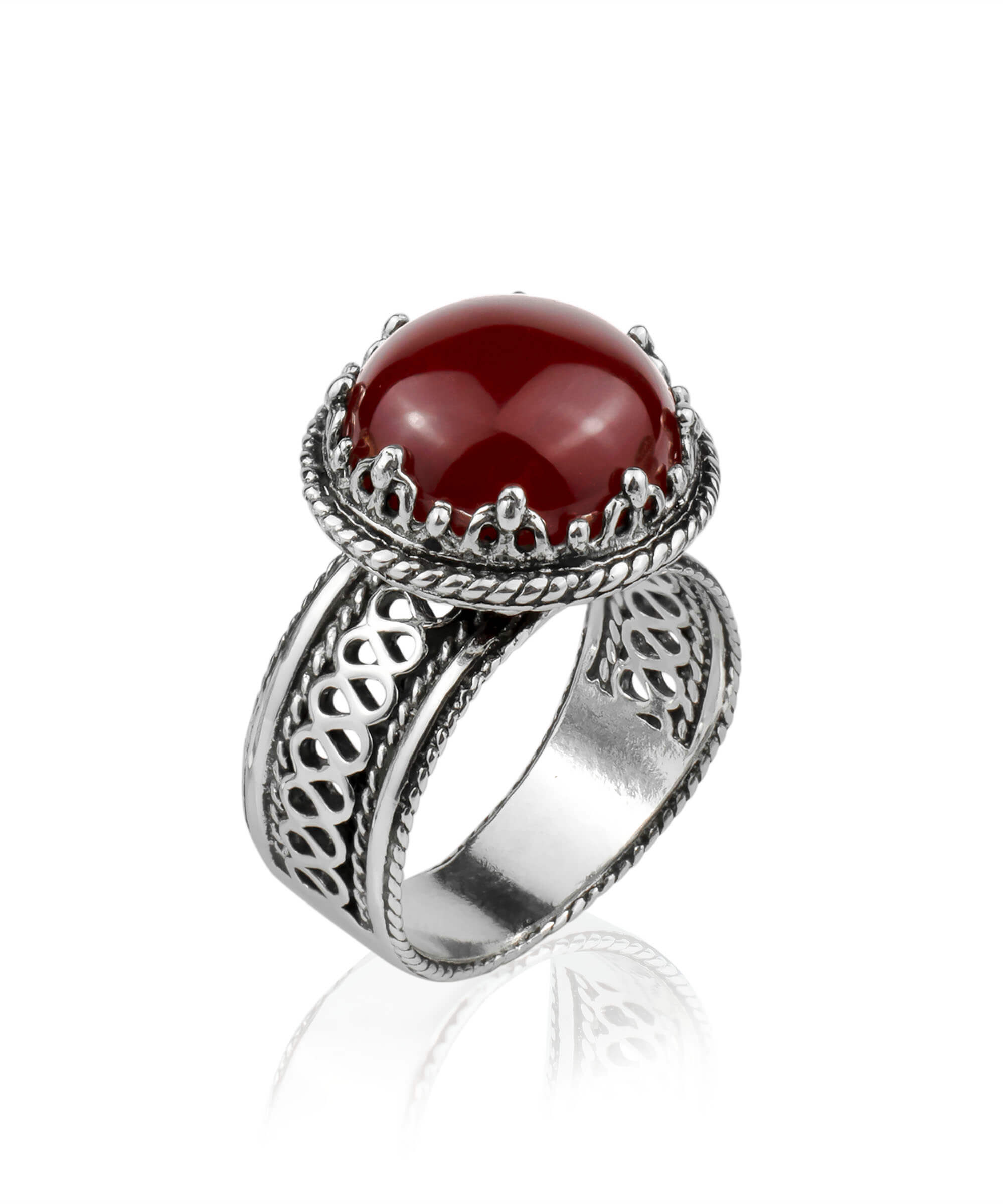 Sterling silver filigree cocktail ring featuring a round cut carnelian gemstone, showcasing intricate metalwork and a polished finish.