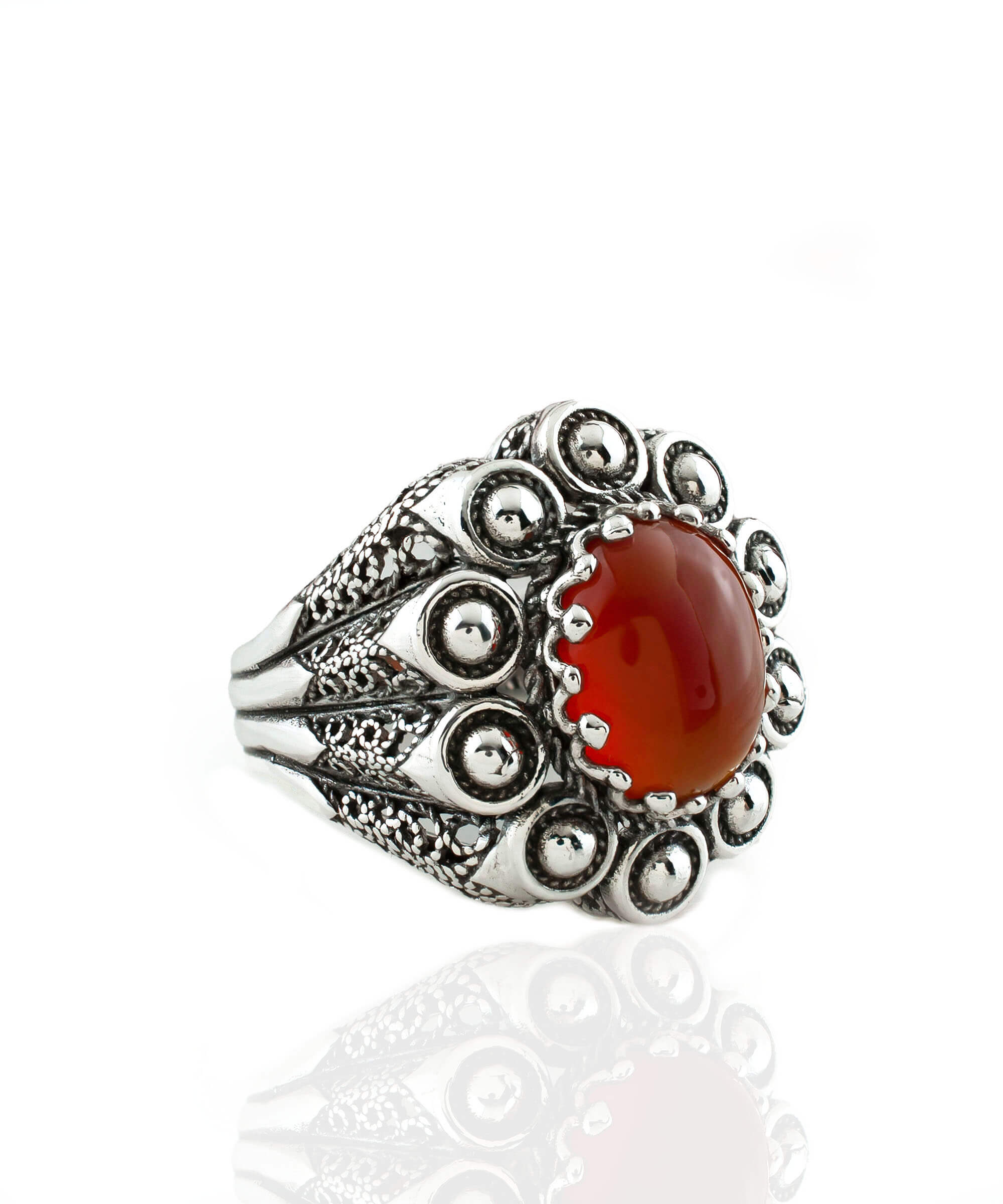 A handcrafted filigree art dome ring featuring a vibrant Carnelian gemstone set in oxidized 925 sterling silver, elegantly displayed in a gift box.