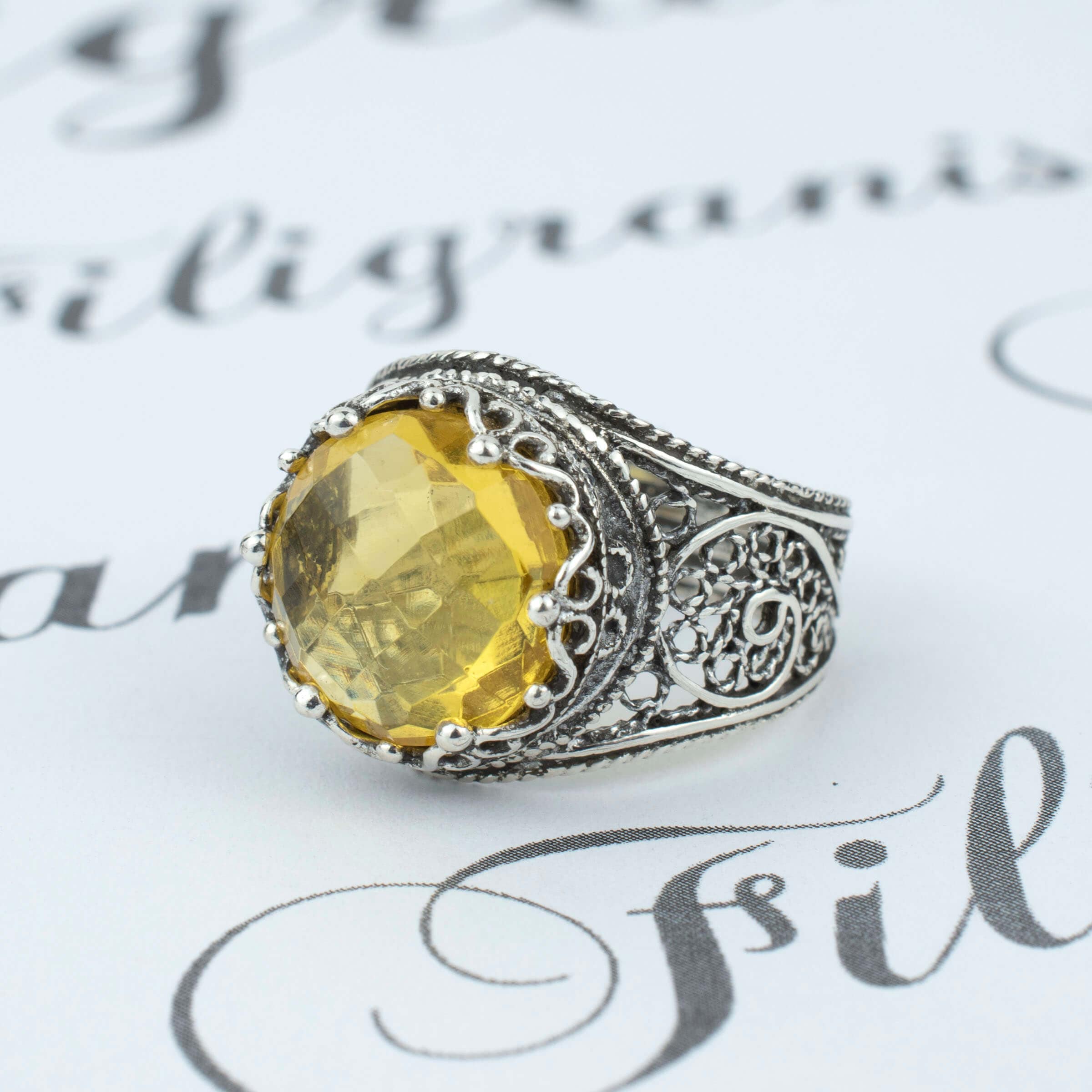 Handmade filigree art silver ring featuring a stunning 12mm citrine gemstone in a crown design, showcasing intricate craftsmanship.