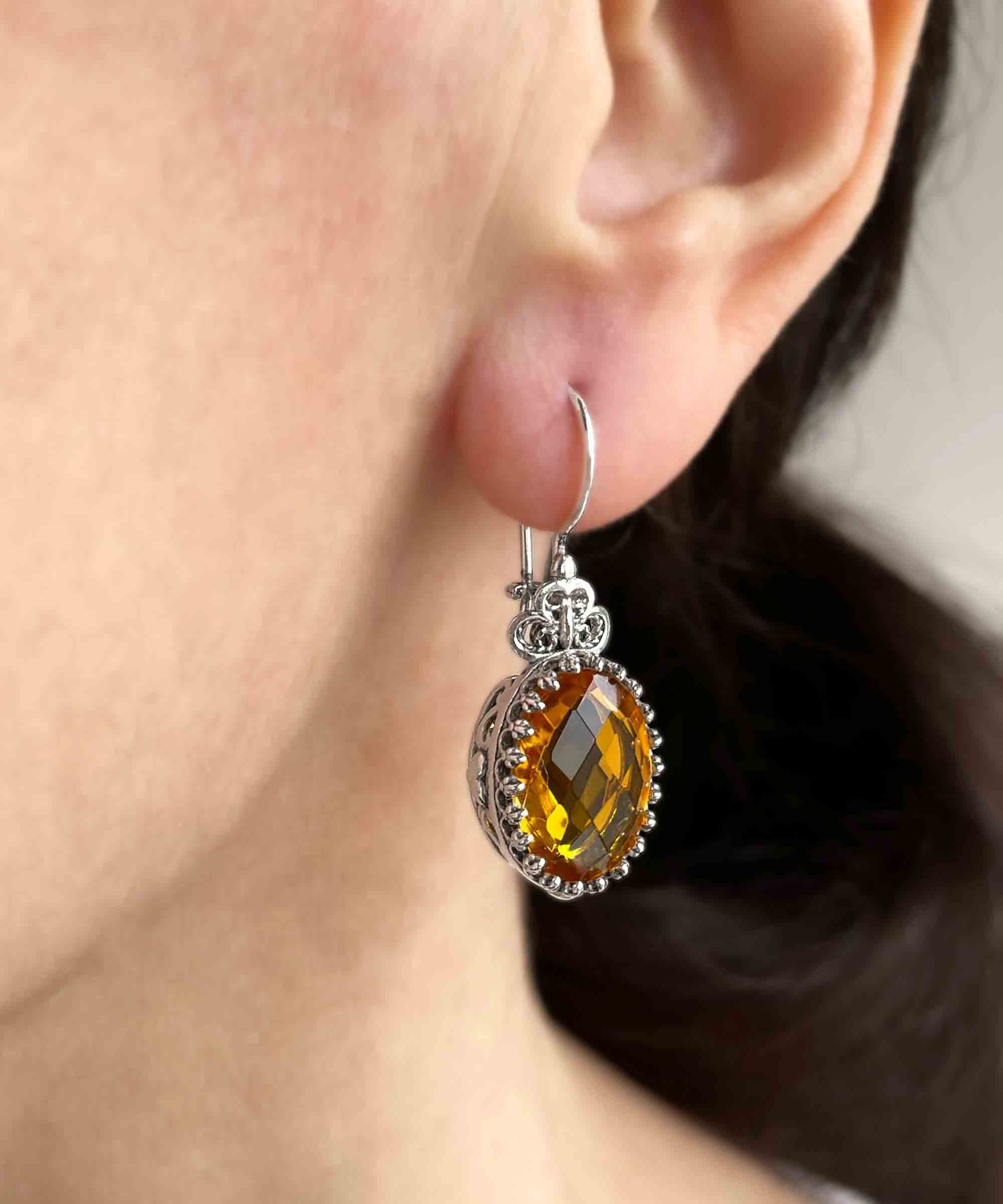 Elegant filigree art silver drop earrings featuring a heart design and a vibrant citrine gemstone.