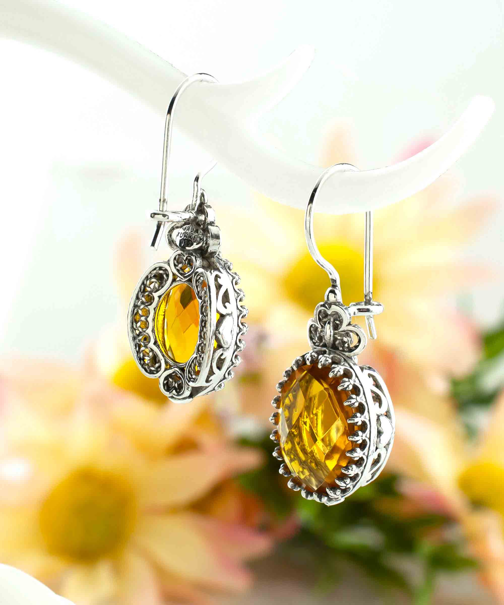 Elegant filigree art silver drop earrings featuring a heart design and a vibrant citrine gemstone.