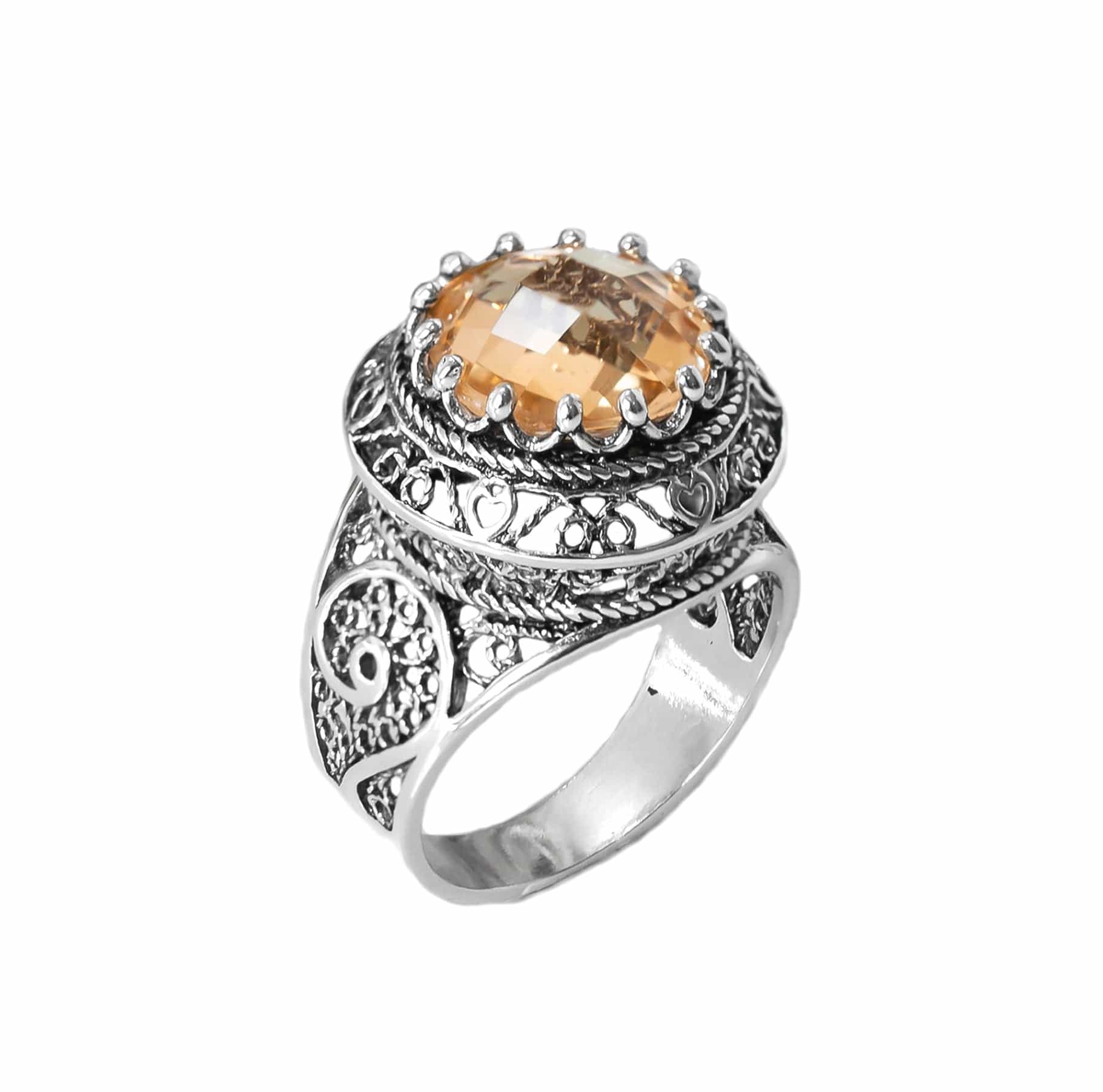 A stunning silver statement ring featuring intricate filigree design and a round faceted Citrine gemstone, elegantly displayed in a luxurious gift box.