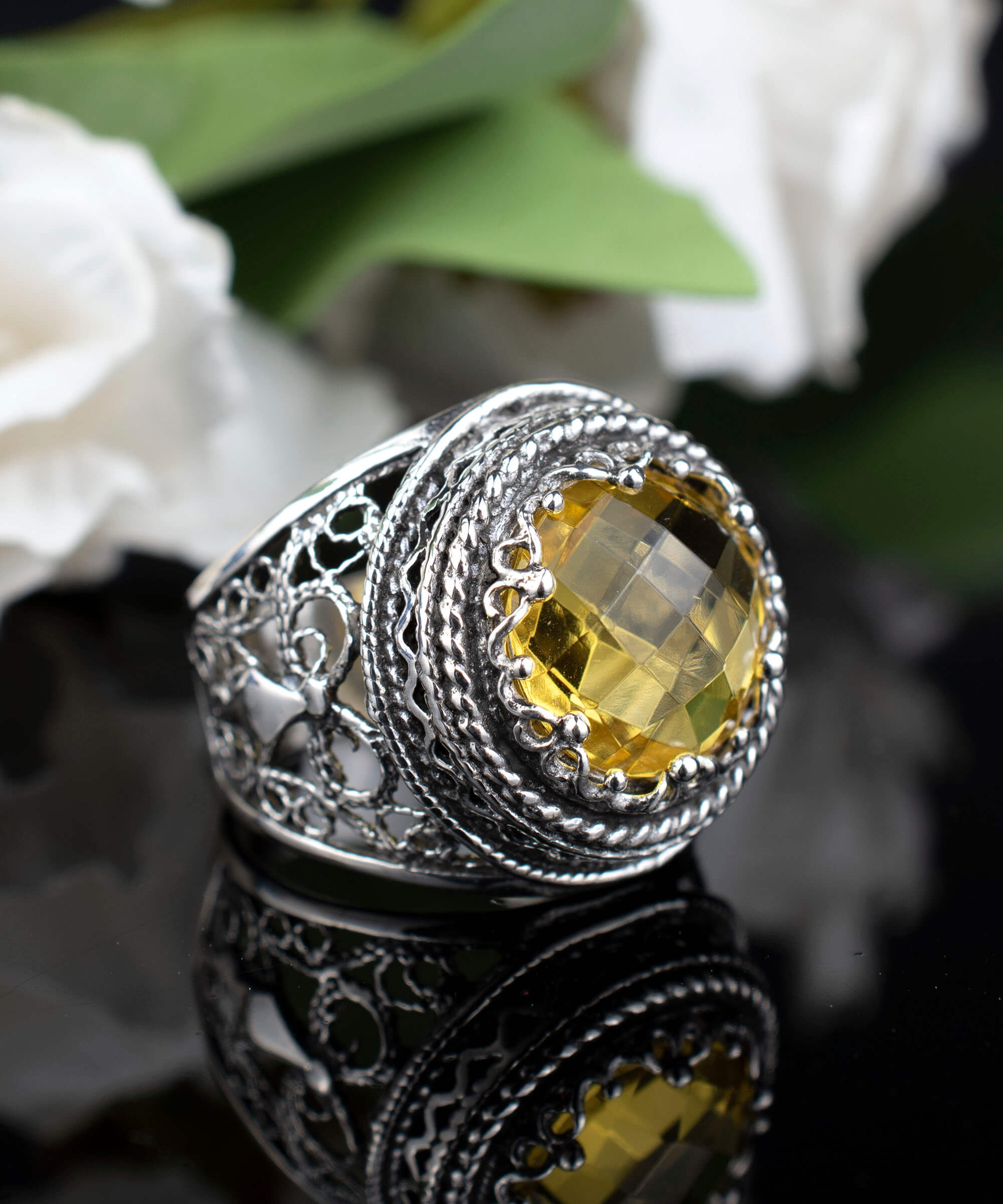 A stunning sterling silver bold ring featuring a 12mm double-sided faceted citrine gemstone, showcasing intricate filigree art design.