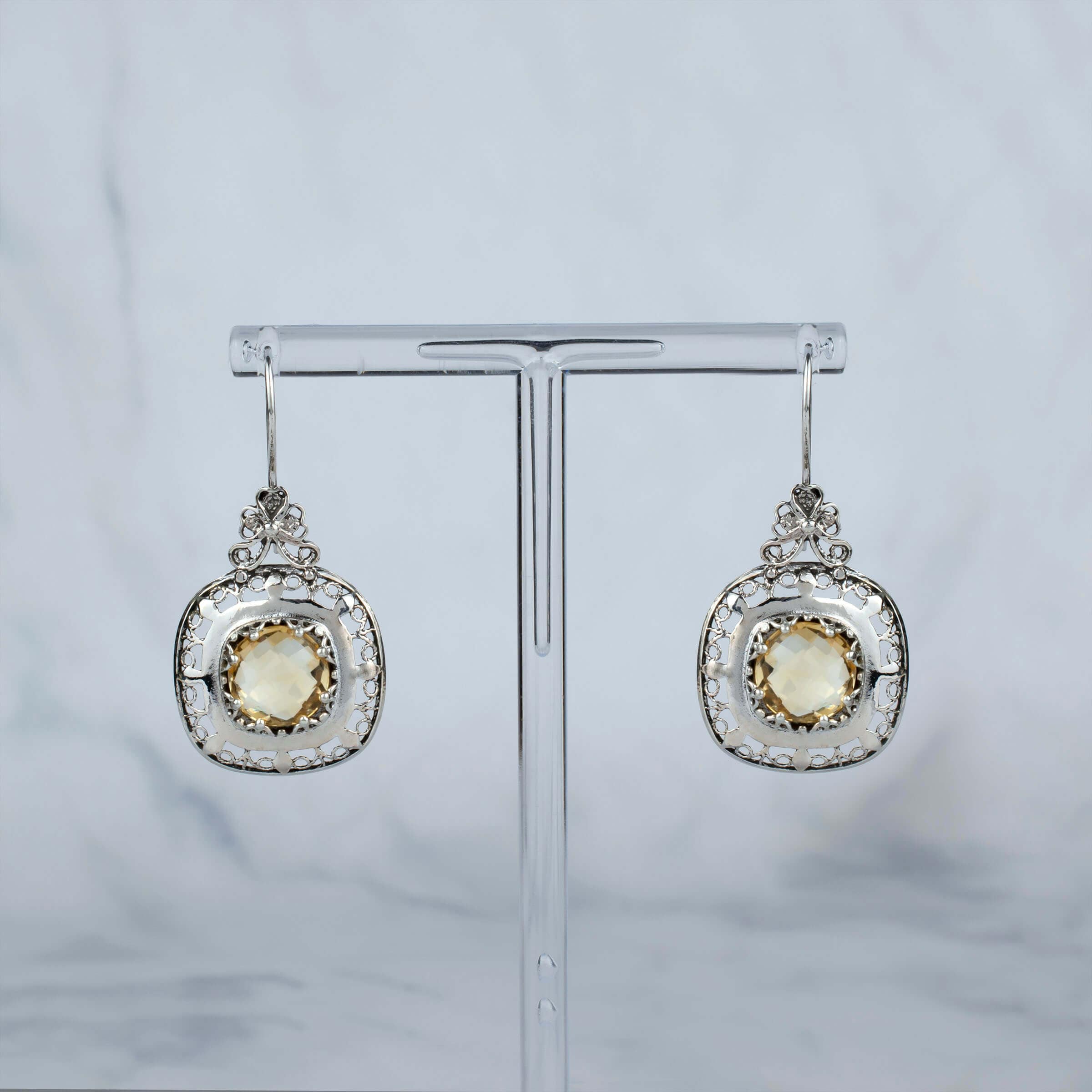 Elegant sterling silver drop earrings featuring intricate filigree design and a vibrant 10mm round-cut citrine gemstone.