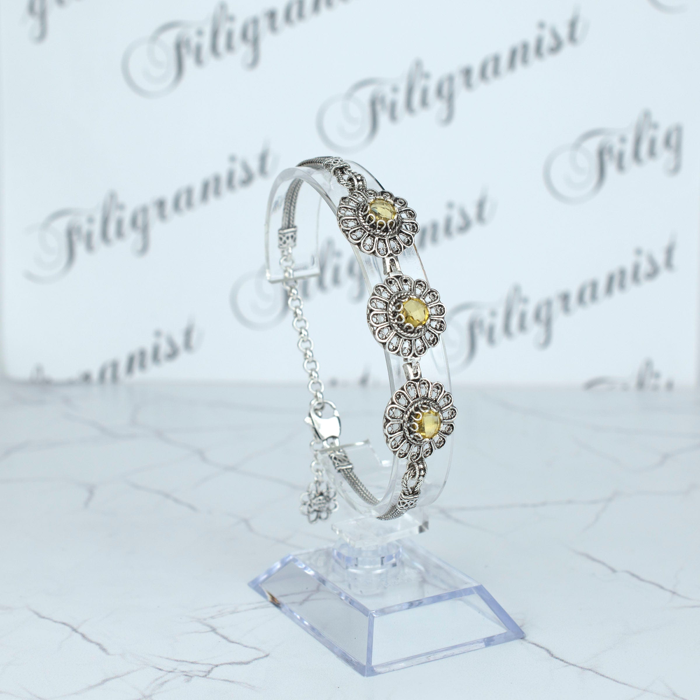 Elegant sterling silver filigree bracelet featuring a double-sided faceted citrine gemstone, perfect for women.