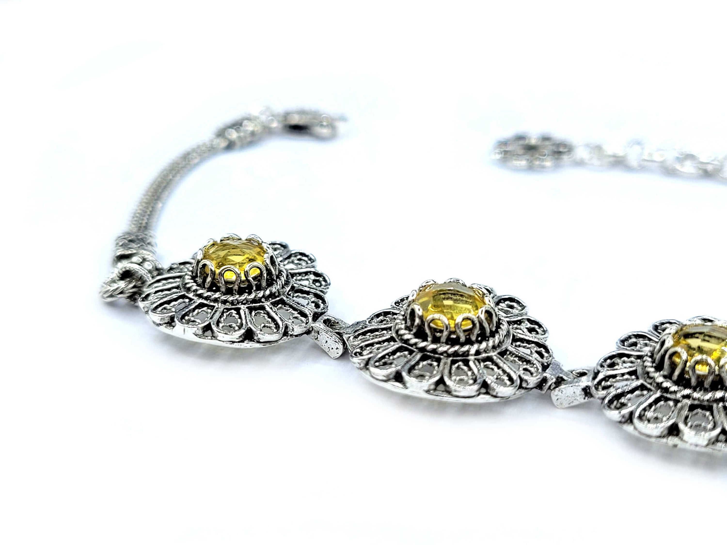 Elegant sterling silver filigree bracelet featuring a double-sided faceted citrine gemstone, perfect for women.