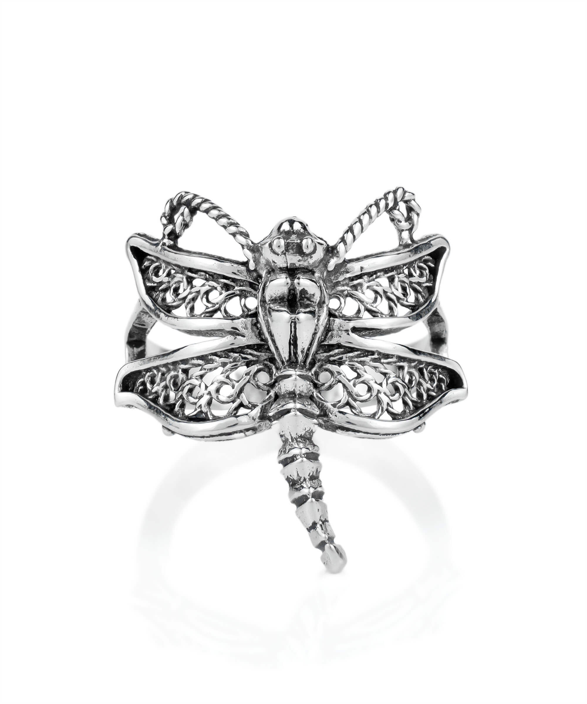 A stunning silver cocktail ring featuring an intricate dragonfly filigree design, showcasing delicate metal strands and a polished finish.