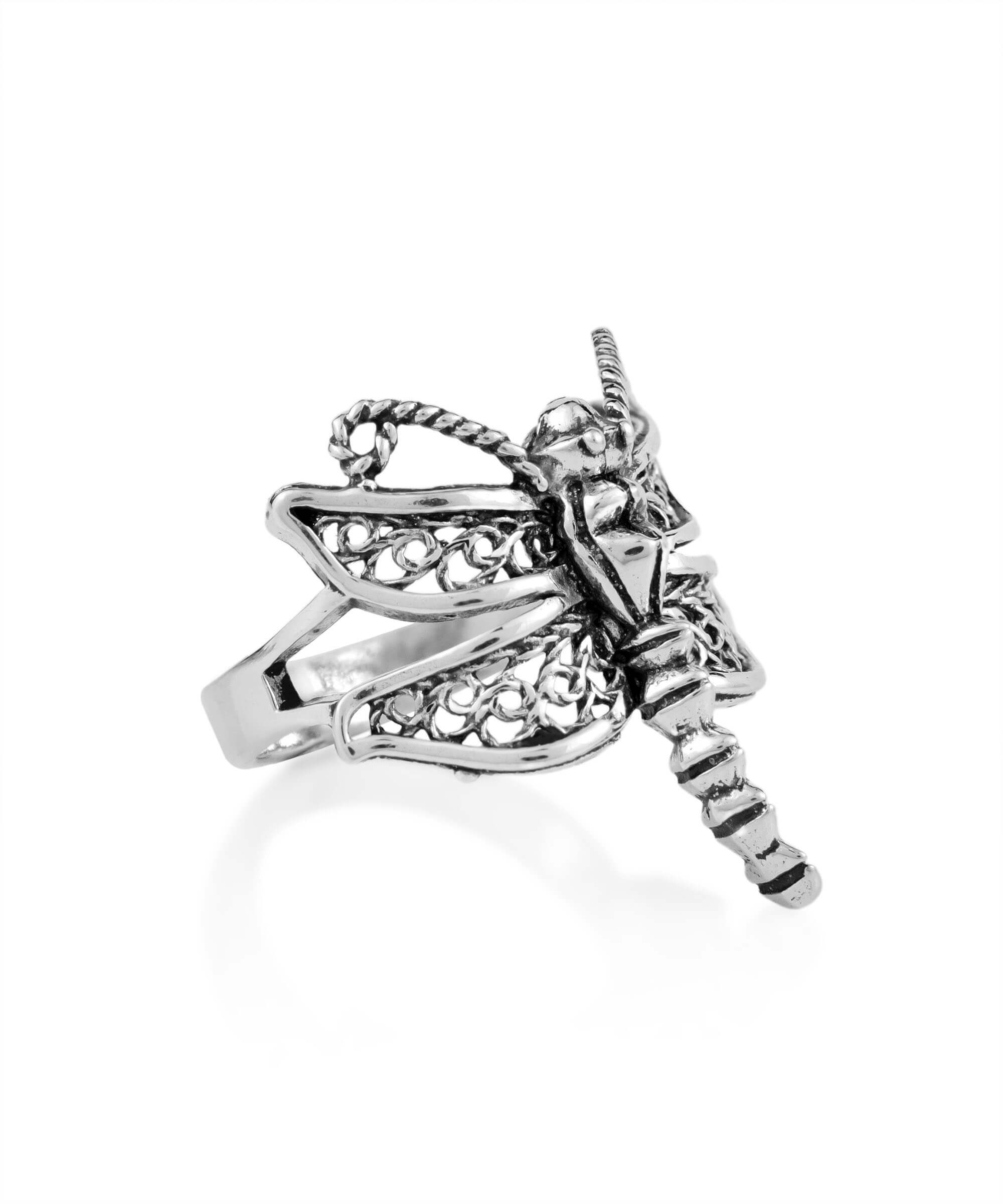 A stunning silver cocktail ring featuring an intricate dragonfly filigree design, showcasing delicate metal strands and a polished finish.