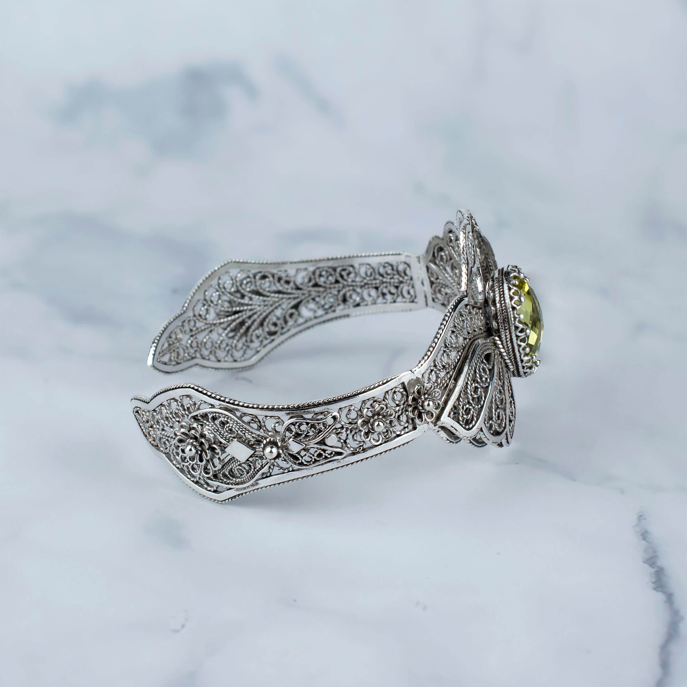 Sterling silver cuff bracelet featuring double swan design and lemon quartz gemstone, elegantly crafted with filigree art.