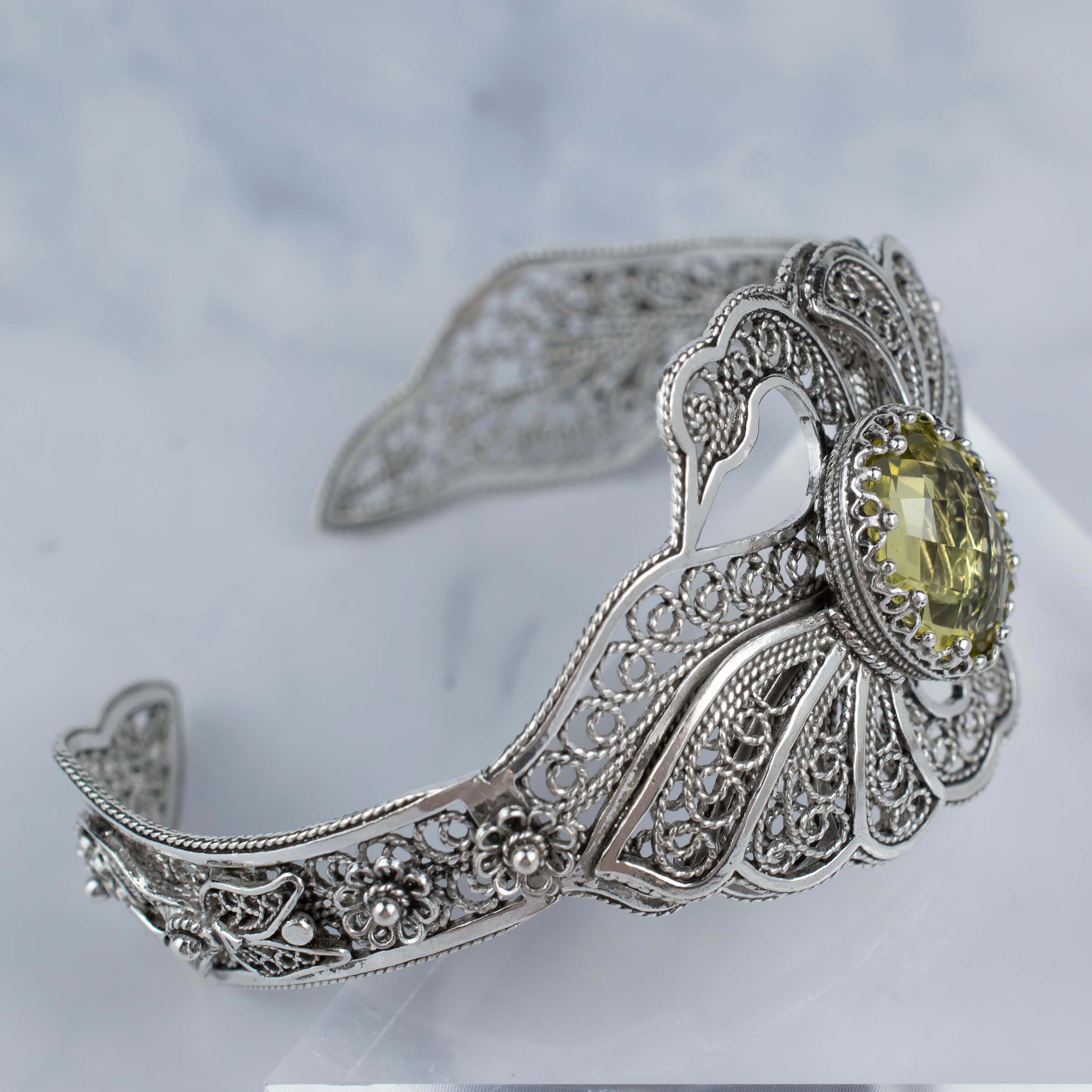 Sterling silver cuff bracelet featuring double swan design and lemon quartz gemstone, elegantly crafted with filigree art.