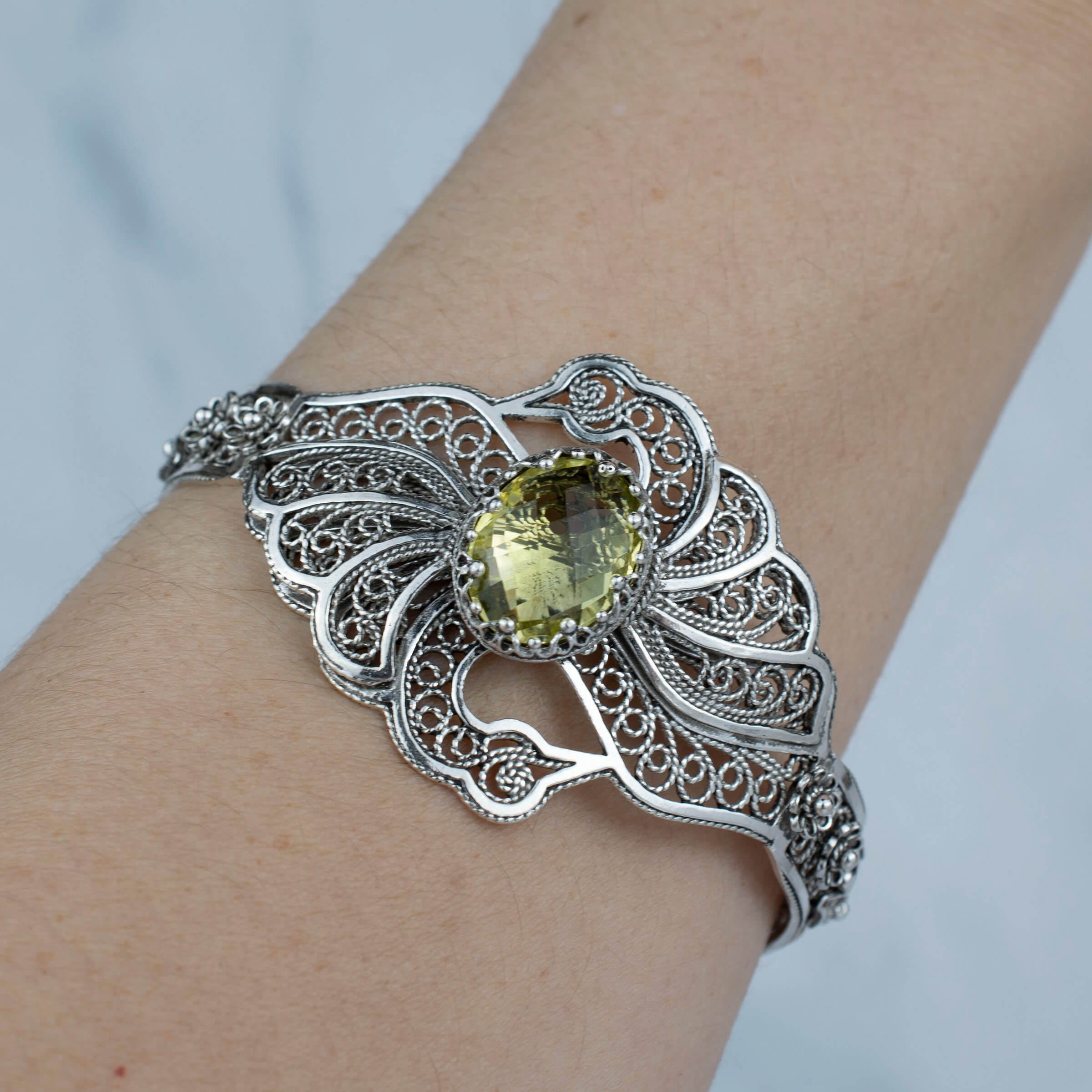 Sterling silver cuff bracelet featuring double swan design and lemon quartz gemstone, elegantly crafted with filigree art.