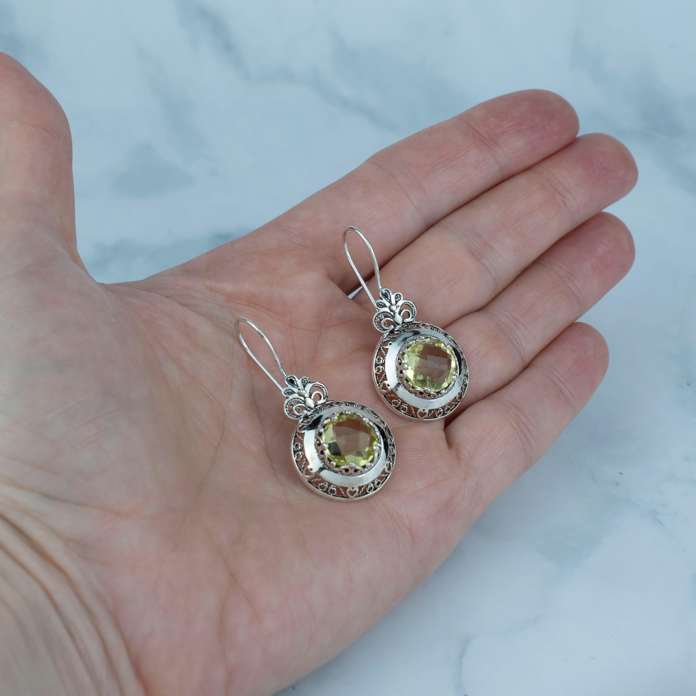 Elegant silver drop earrings featuring intricate filigree art and vibrant lemon quartz gemstones, perfect for women.