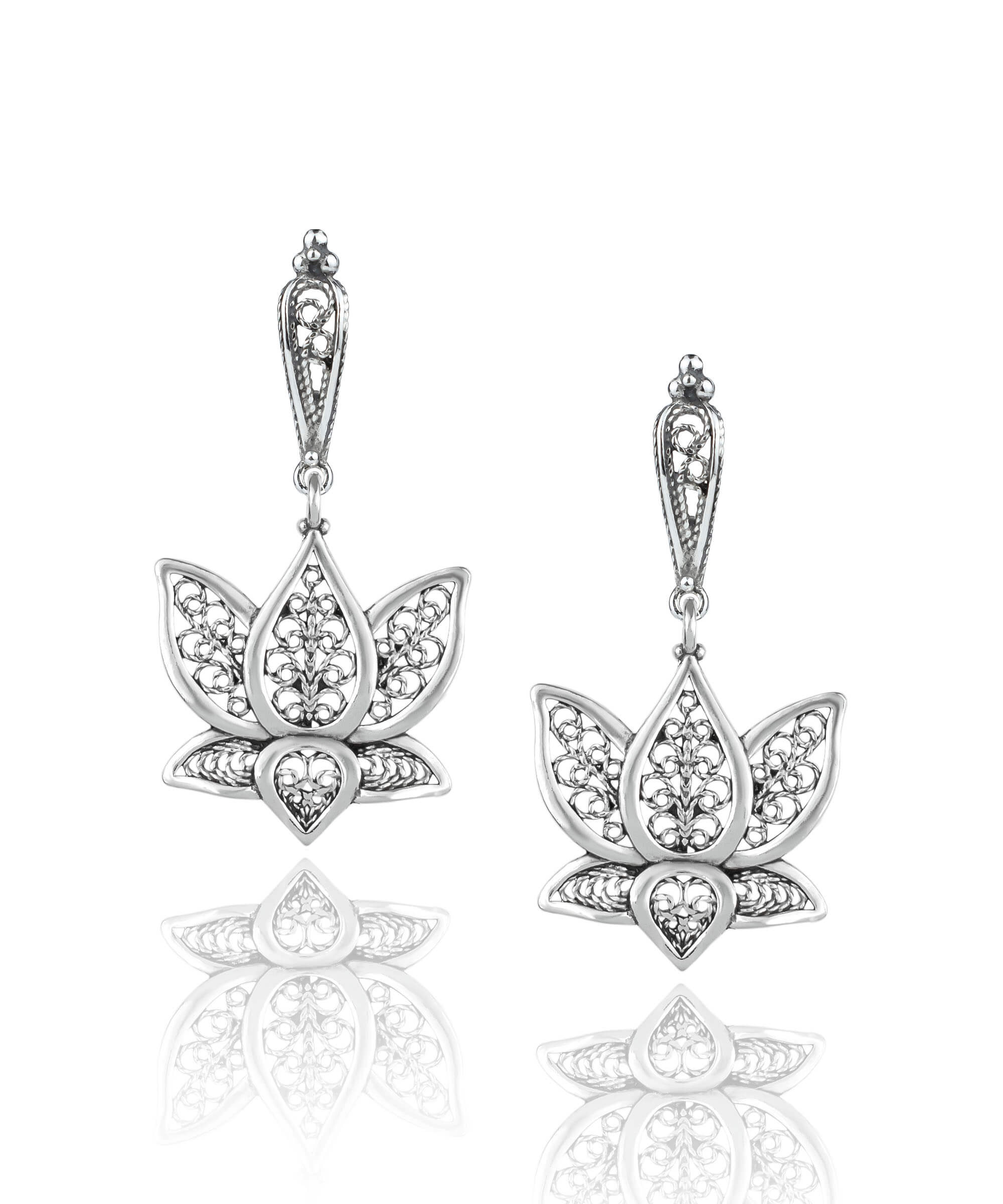 Elegant silver dangle drop earrings featuring intricate filigree art inspired by the lotus flower, showcasing craftsmanship and beauty.