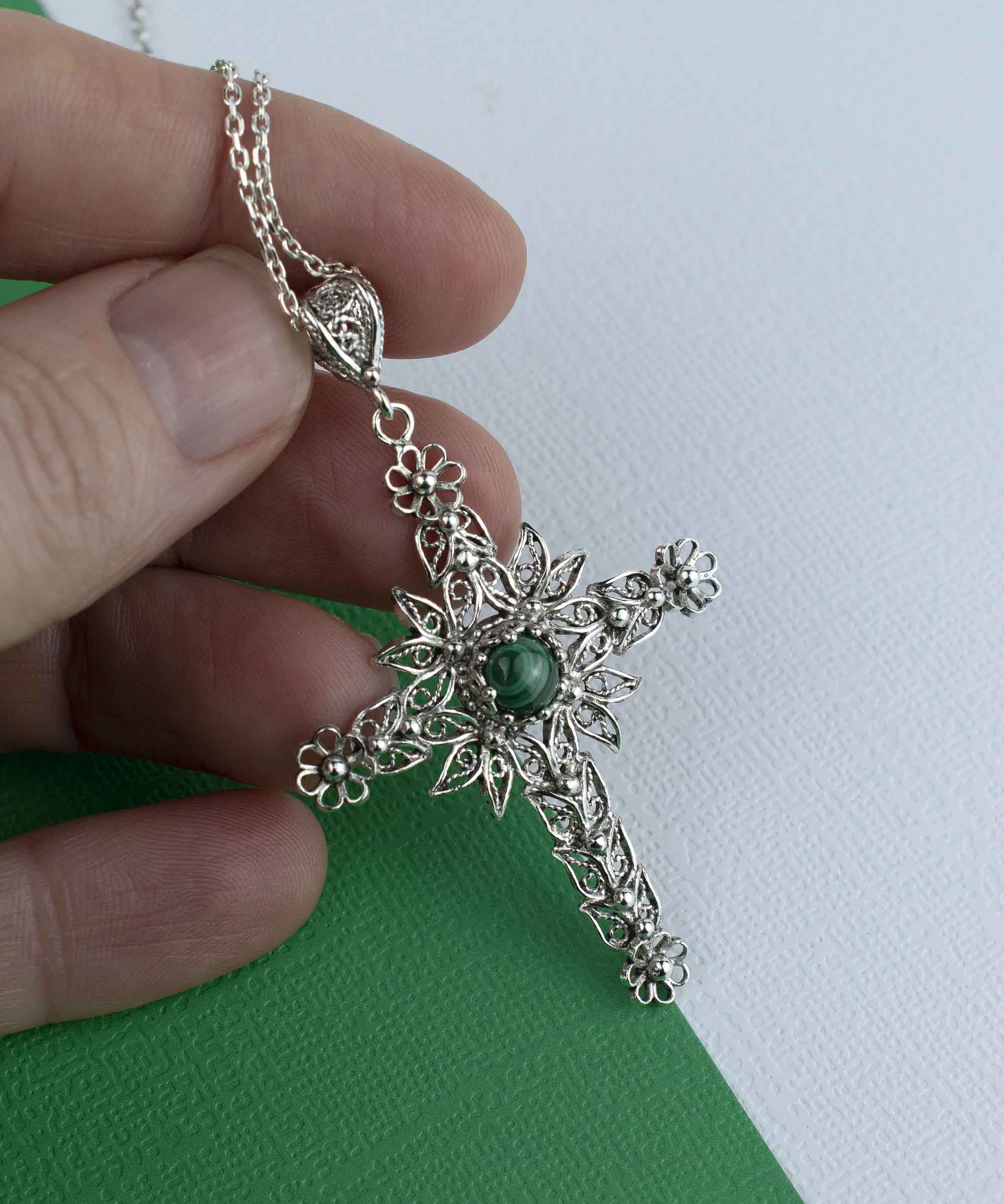 Elegant silver cross pendant necklace featuring intricate filigree art and a round-cut malachite gemstone, perfect for women.