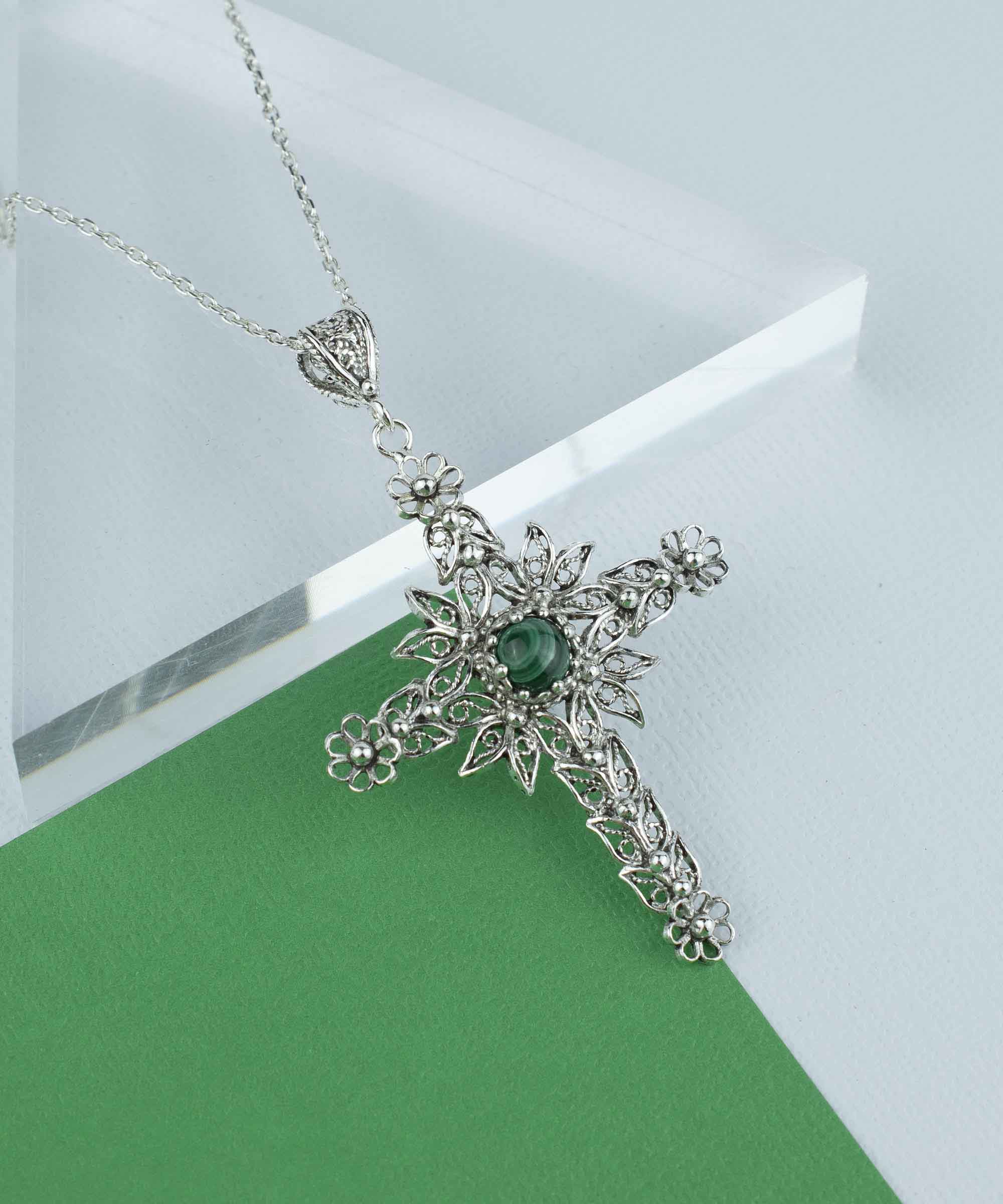 Elegant silver cross pendant necklace featuring intricate filigree art and a round-cut malachite gemstone, perfect for women.