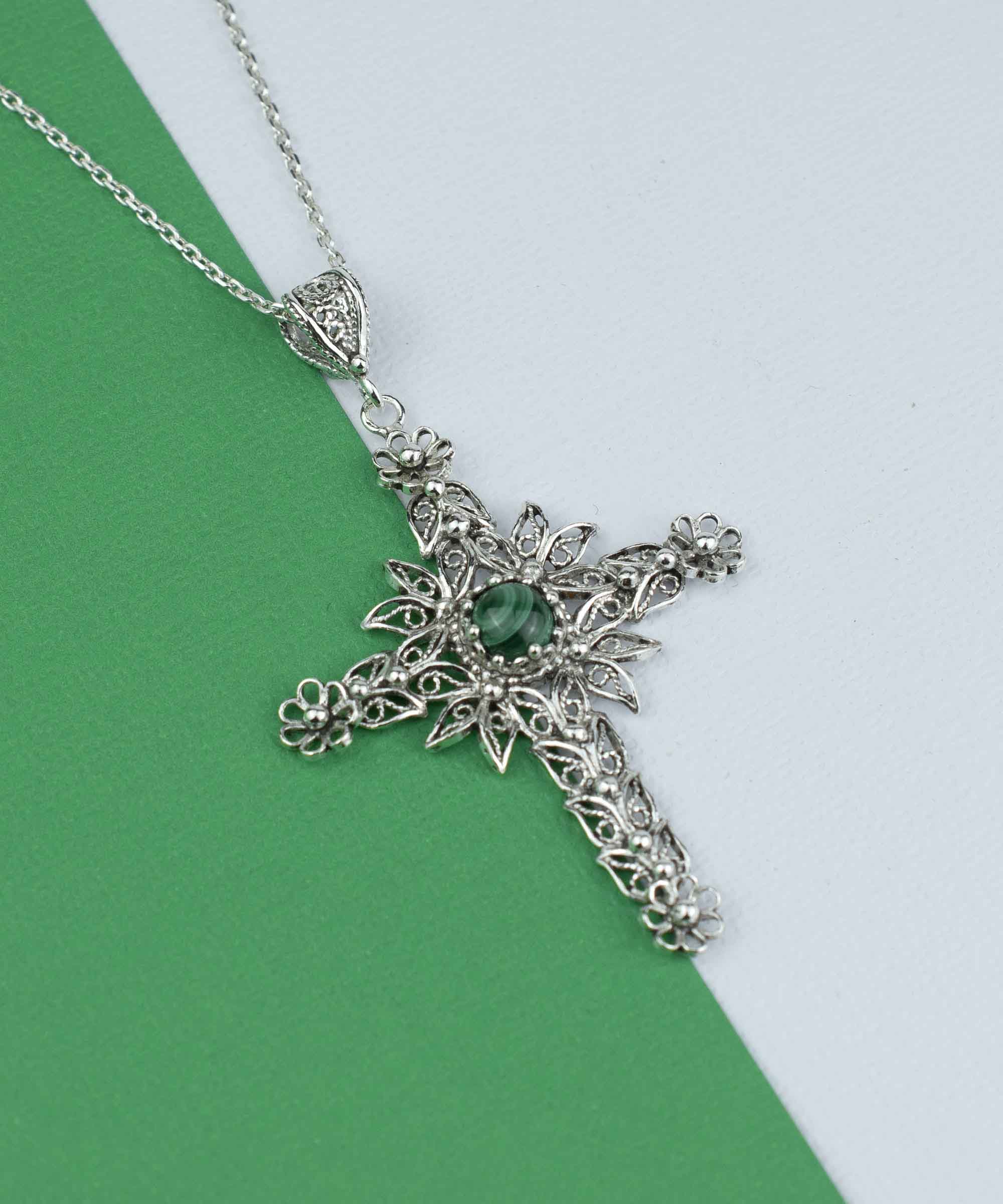 Elegant silver cross pendant necklace featuring intricate filigree art and a round-cut malachite gemstone, perfect for women.