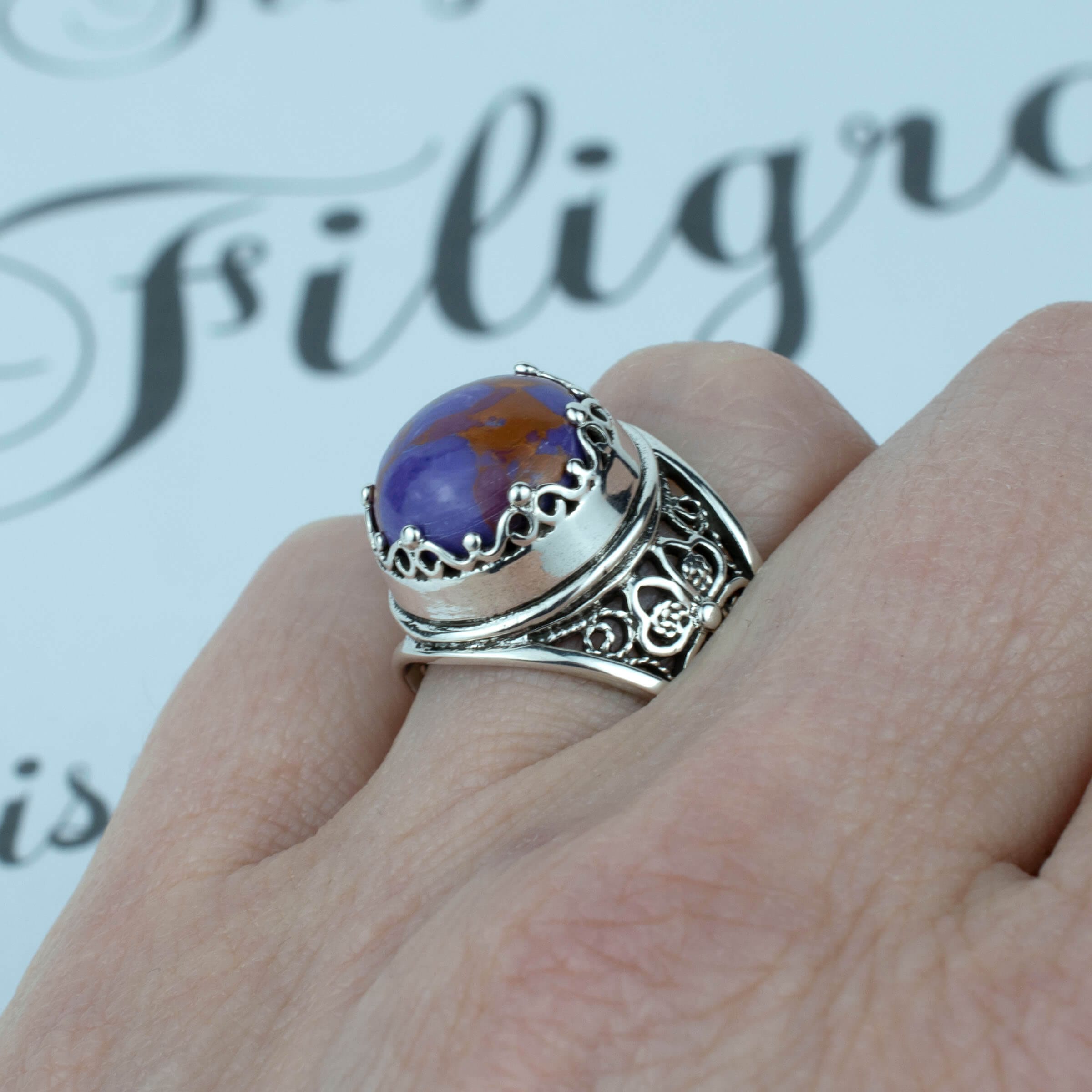 Sterling silver filigree art ring featuring a round rose cut Mojave turquoise gemstone, elegantly designed with intricate metalwork.