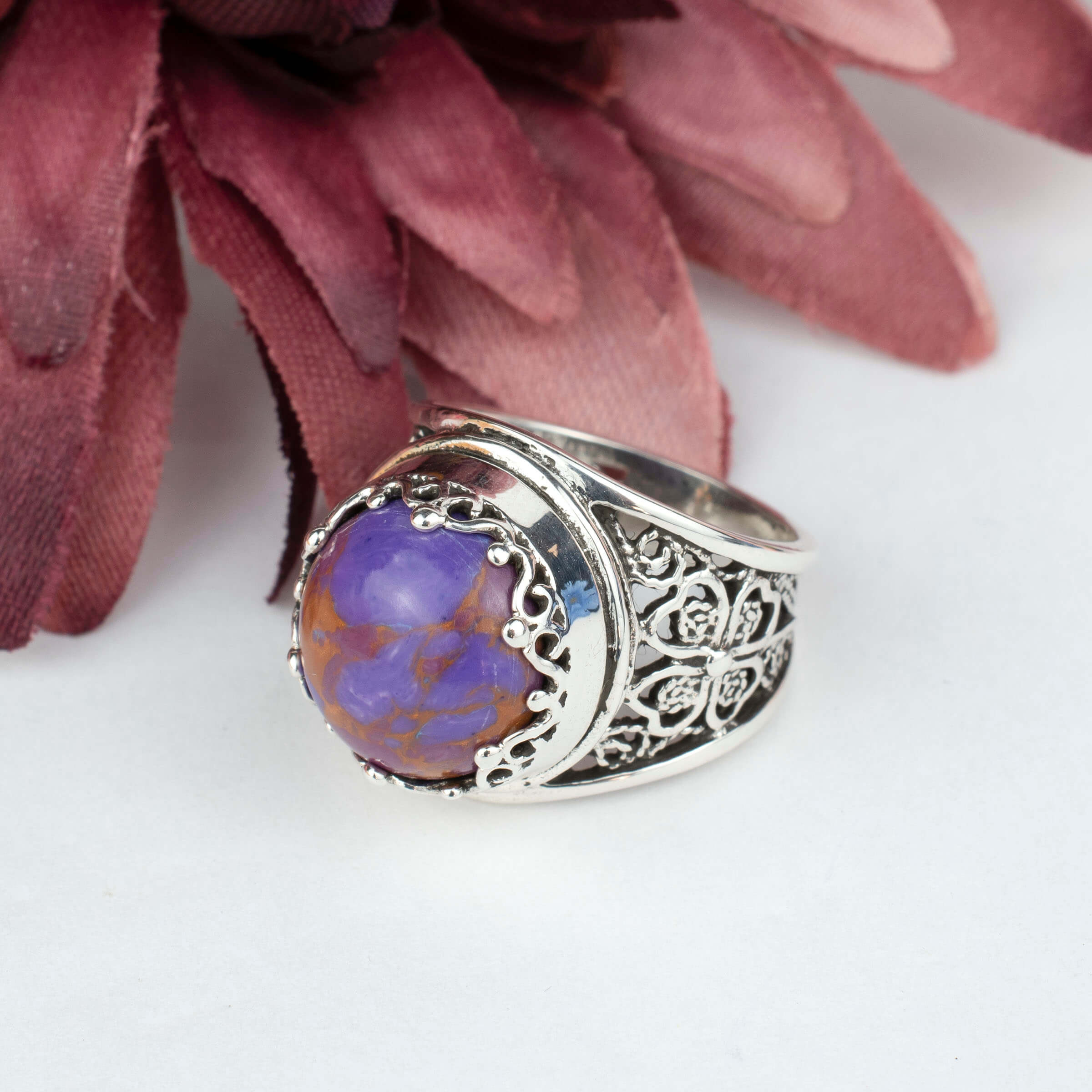 Sterling silver filigree art ring featuring a round rose cut Mojave turquoise gemstone, elegantly designed with intricate metalwork.