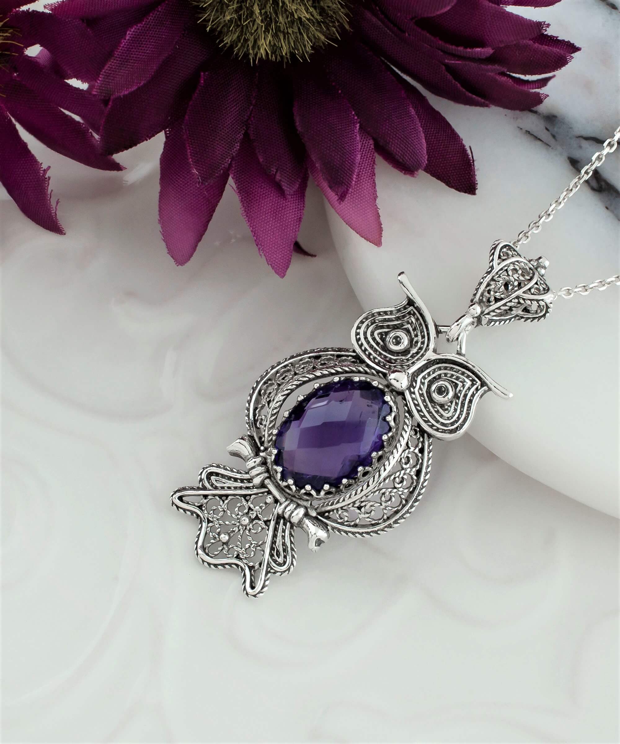 A beautifully crafted 925 Sterling Silver owl pendant featuring an Amethyst gemstone, showcasing intricate filigree details.