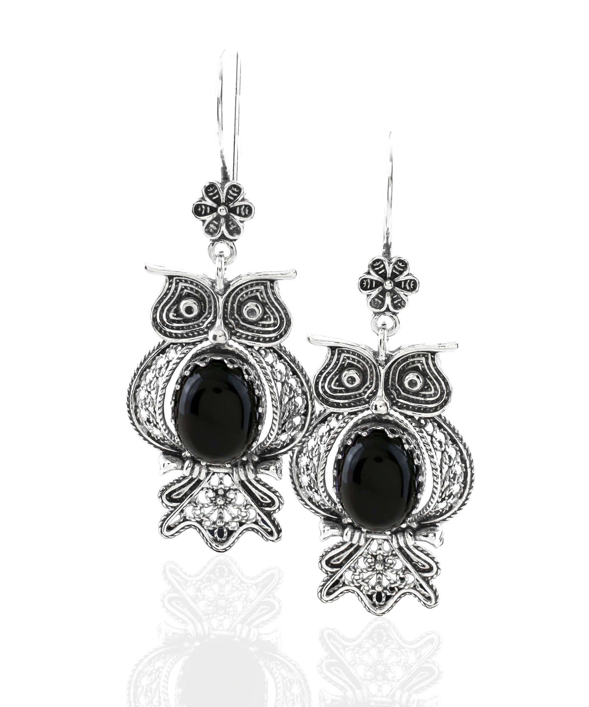 Elegant silver dangle earrings featuring an owl design with intricate filigree work and a central Black Onyx gemstone.