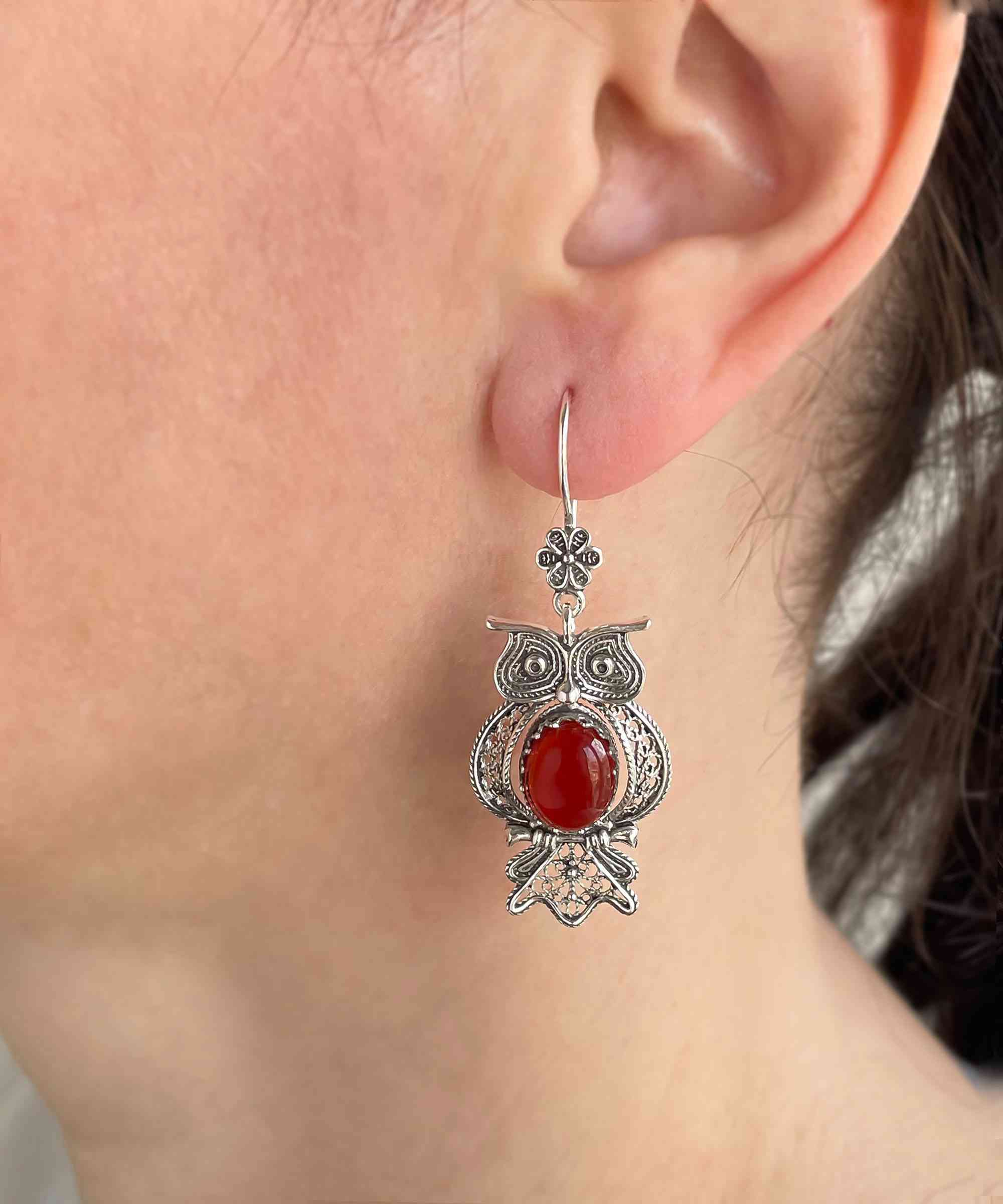 Elegant owl-shaped dangle earrings made of 925 sterling silver with intricate filigree design and a vibrant Carnelian gemstone centerpiece.