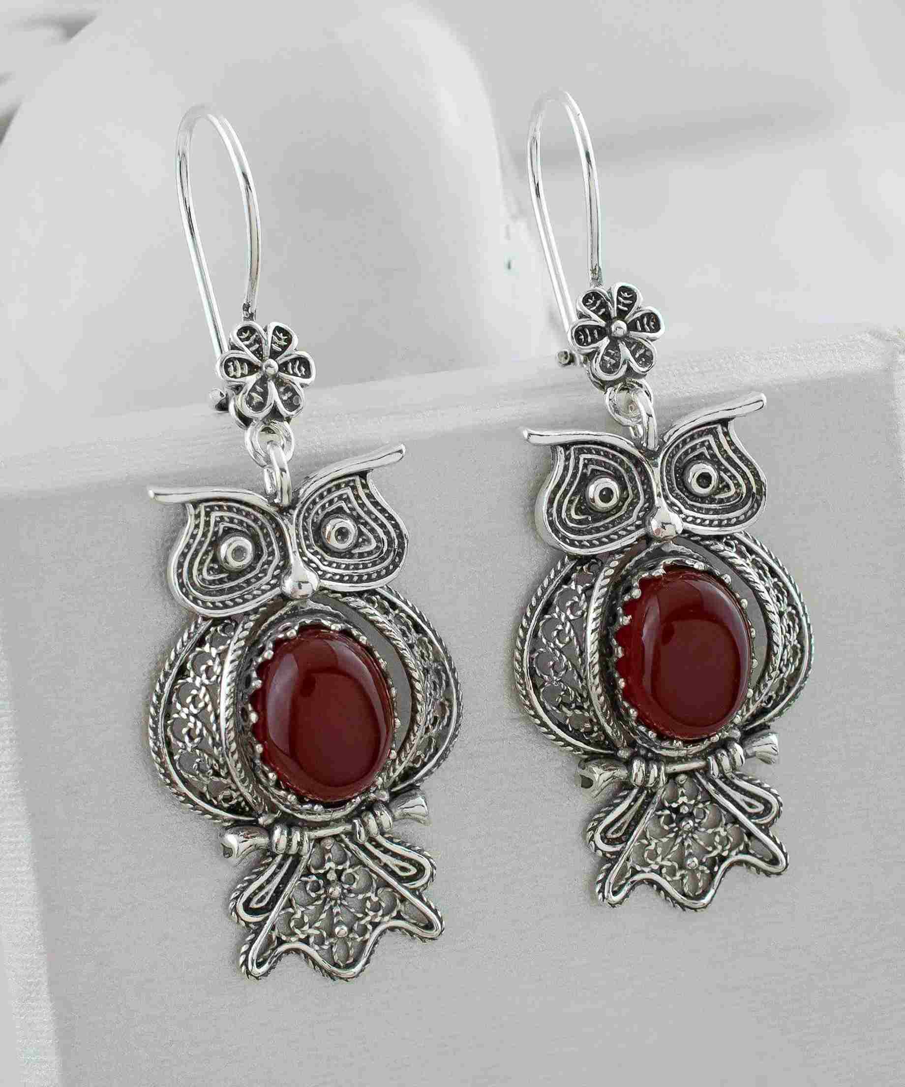 Elegant owl-shaped dangle earrings made of 925 sterling silver with intricate filigree design and a vibrant Carnelian gemstone centerpiece.