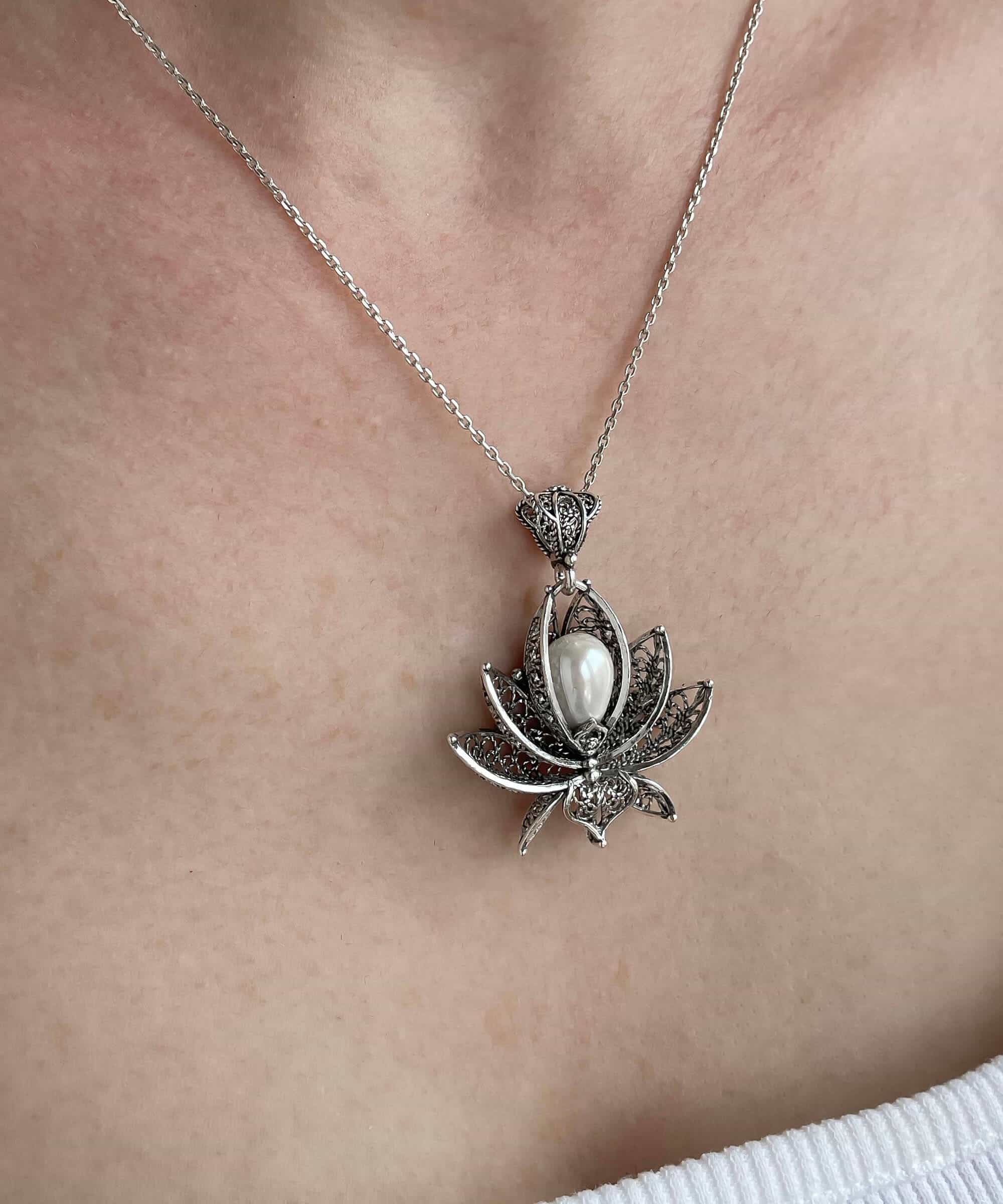 A beautifully crafted 3D lotus flower pendant made of 925 Sterling Silver with a cultured freshwater pearl, showcasing intricate filigree details.