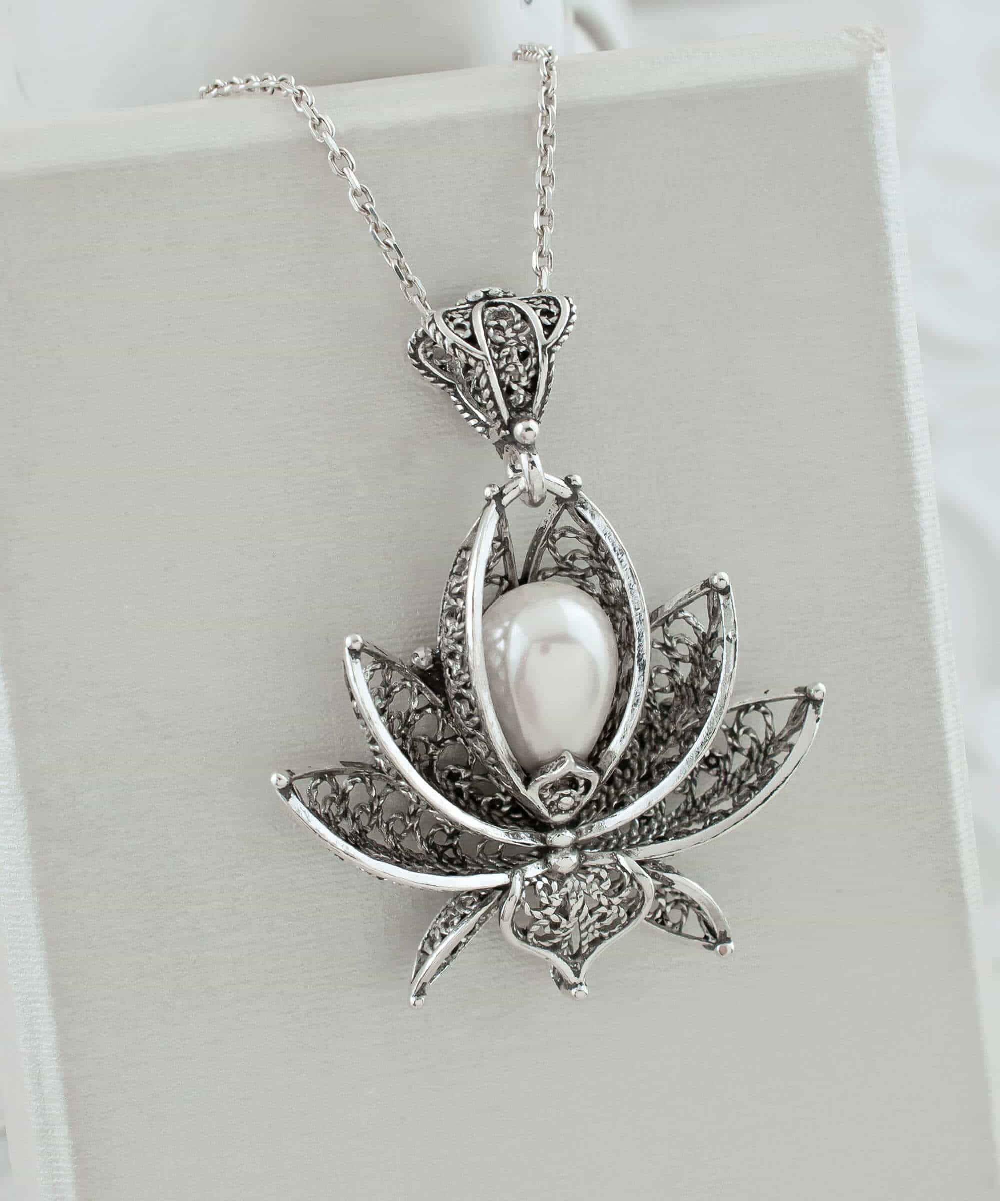 A beautifully crafted 3D lotus flower pendant made of 925 Sterling Silver with a cultured freshwater pearl, showcasing intricate filigree details.