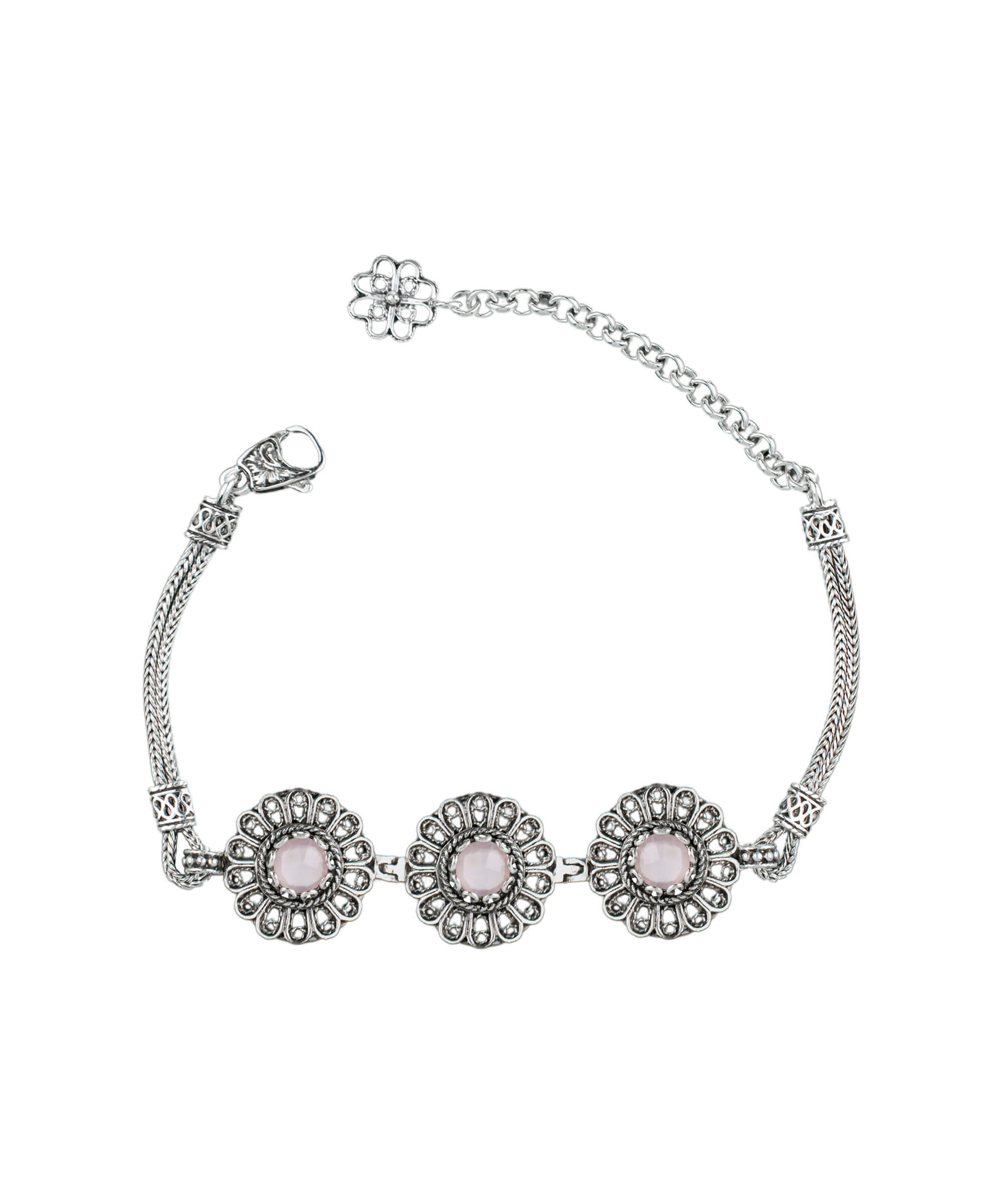 Elegant sterling silver link bracelet featuring intricate filigree art and a double-sided faceted pink chalcedony gemstone.