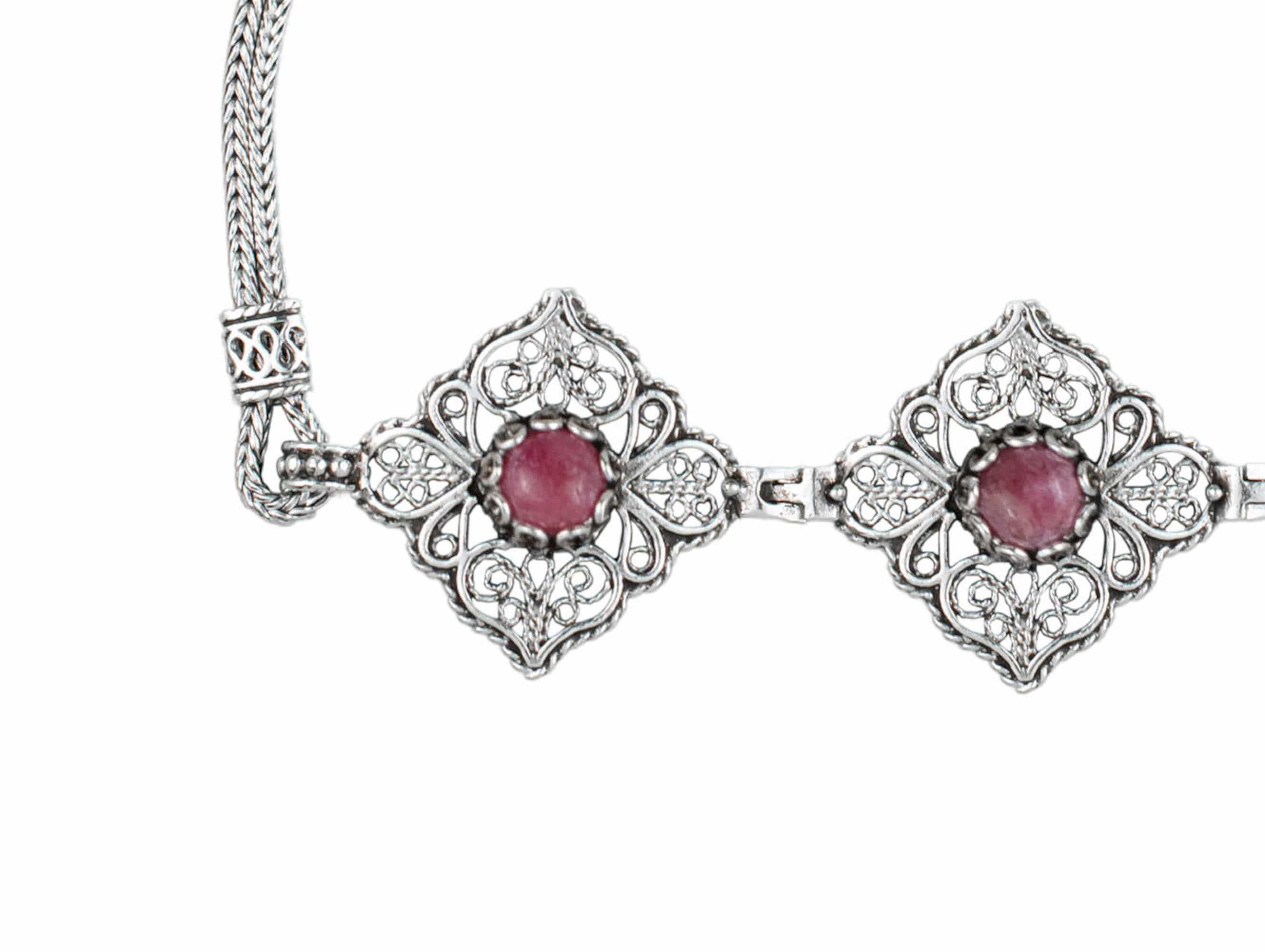 Elegant adjustable silver link bracelet featuring filigree art and a natural rhodonite gemstone, beautifully crafted for women.