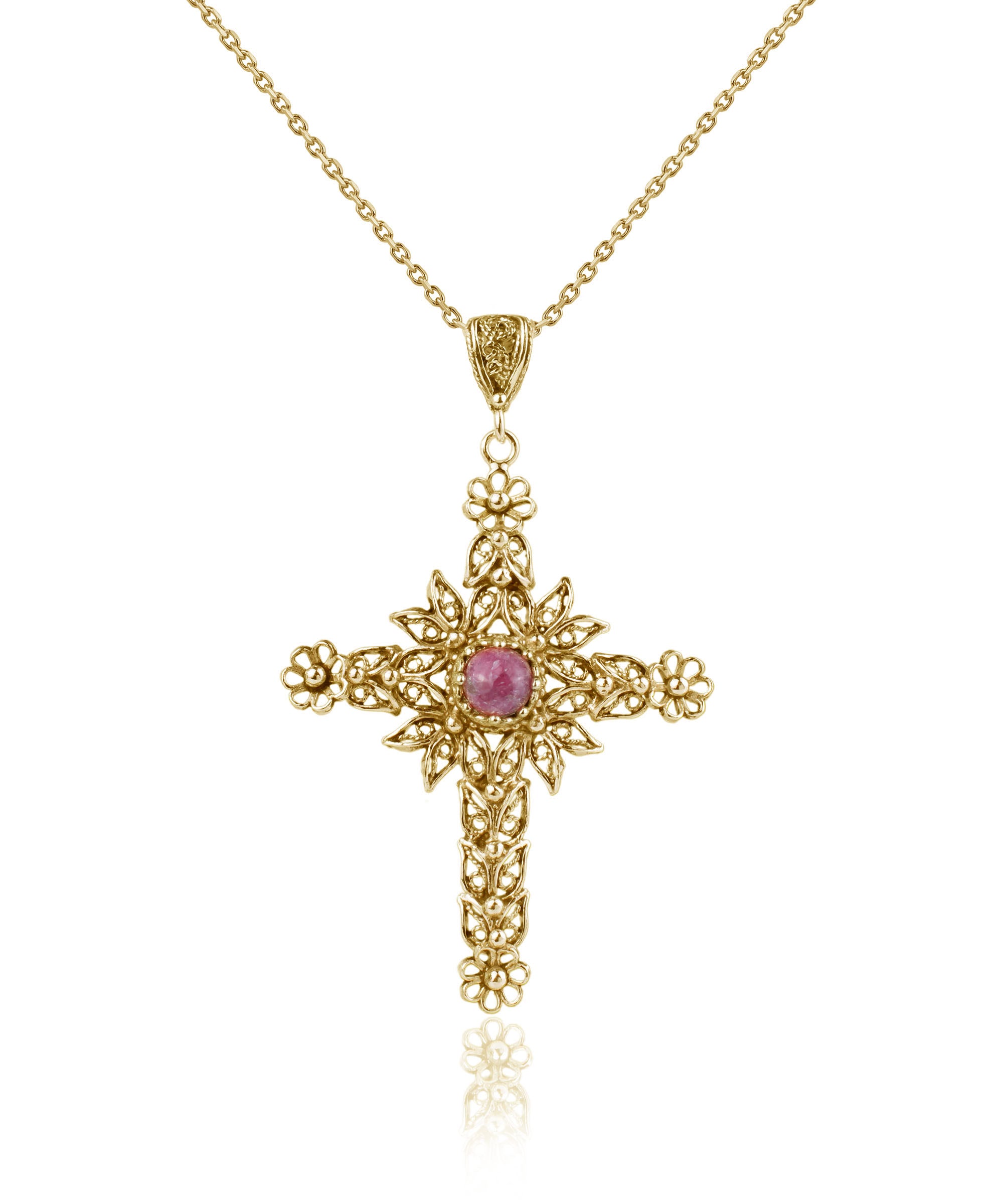 Gold plated silver cross pendant featuring a Rhodonite gemstone with intricate filigree art design.