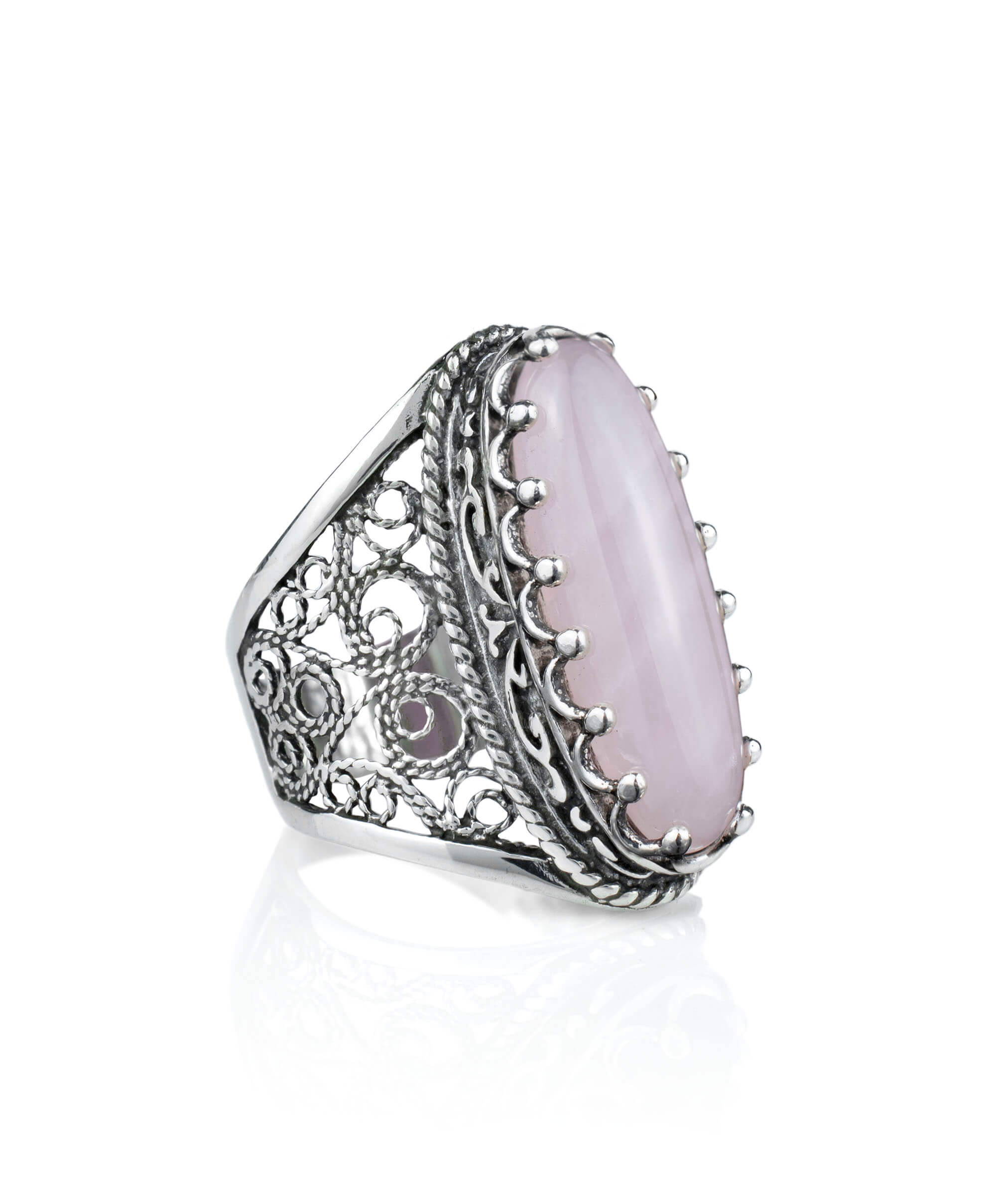 A stunning long statement ring featuring a natural rose quartz gemstone set in intricately designed sterling silver filigree.