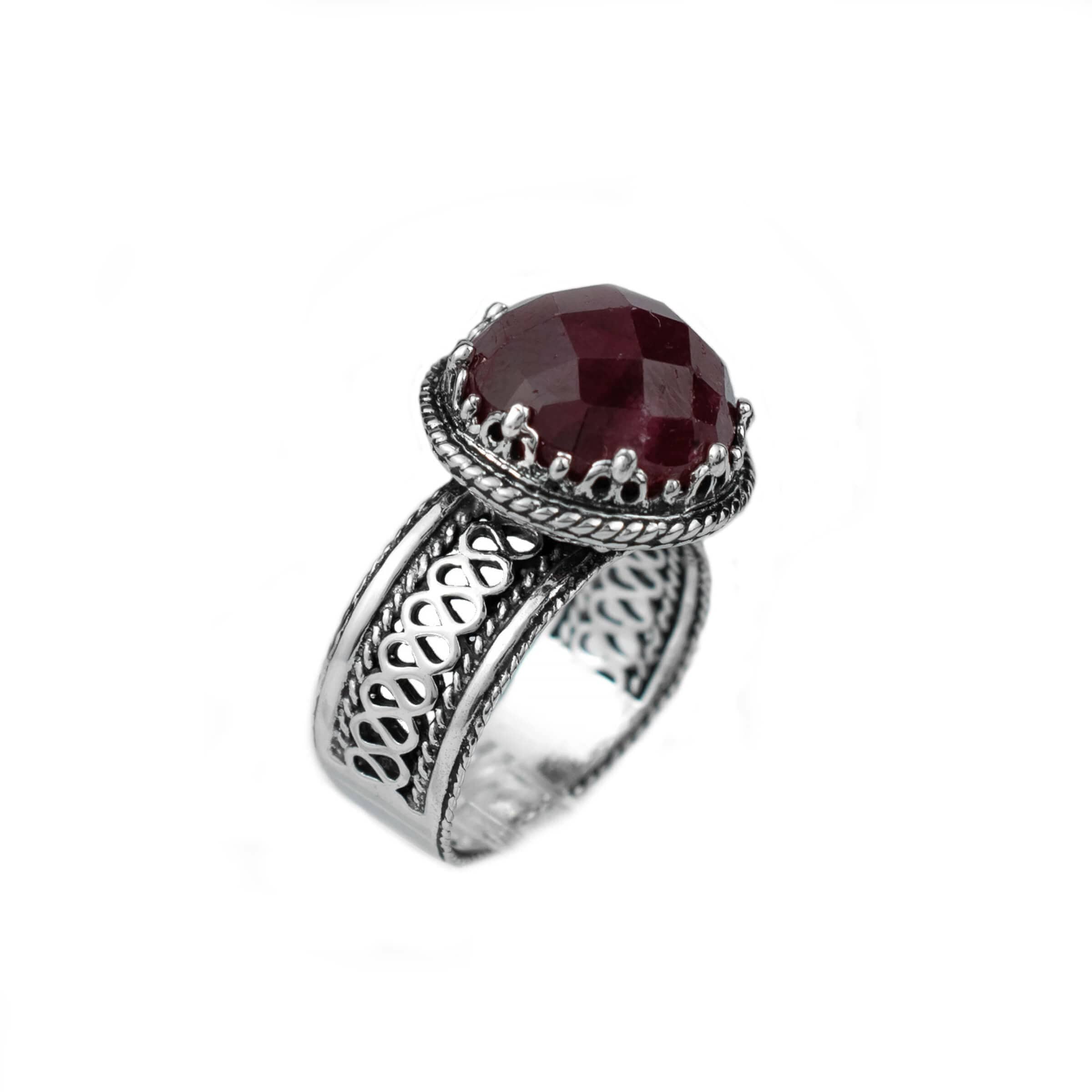 Elegant sterling silver cocktail ring featuring a 12 mm faceted ruby corundum gemstone with intricate filigree design.