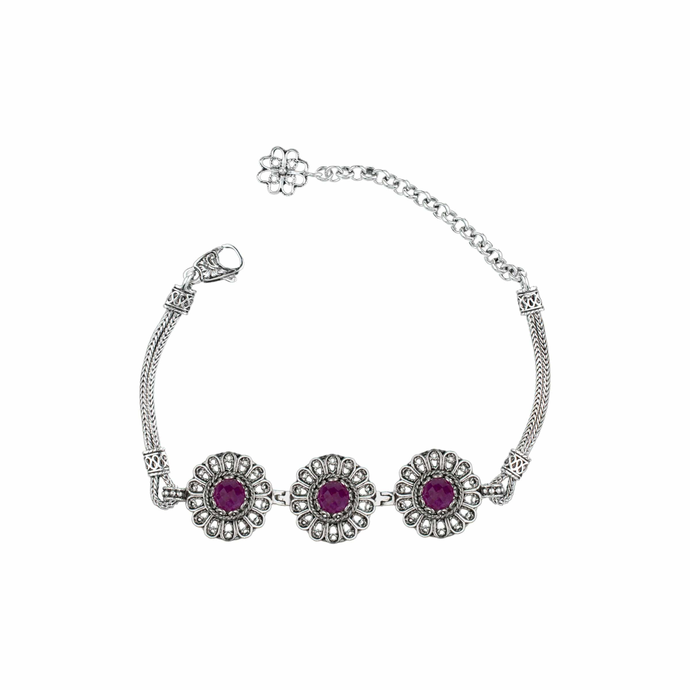 Elegant sterling silver link bracelet featuring filigree art and ruby corundum gemstones, perfect for women.