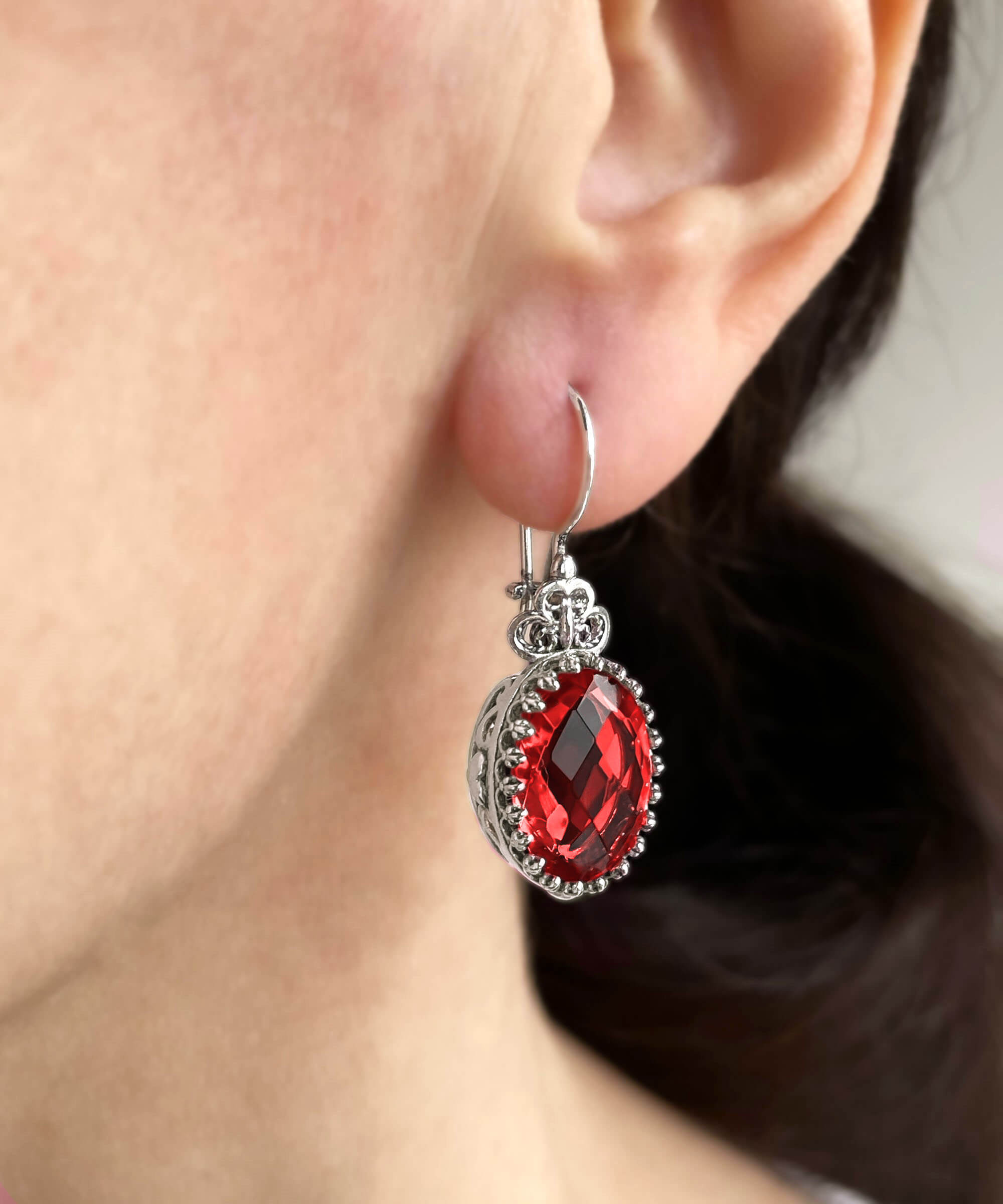 Elegant silver earrings featuring intricate filigree art and a vibrant Ruby Quartz gemstone in a heart design.