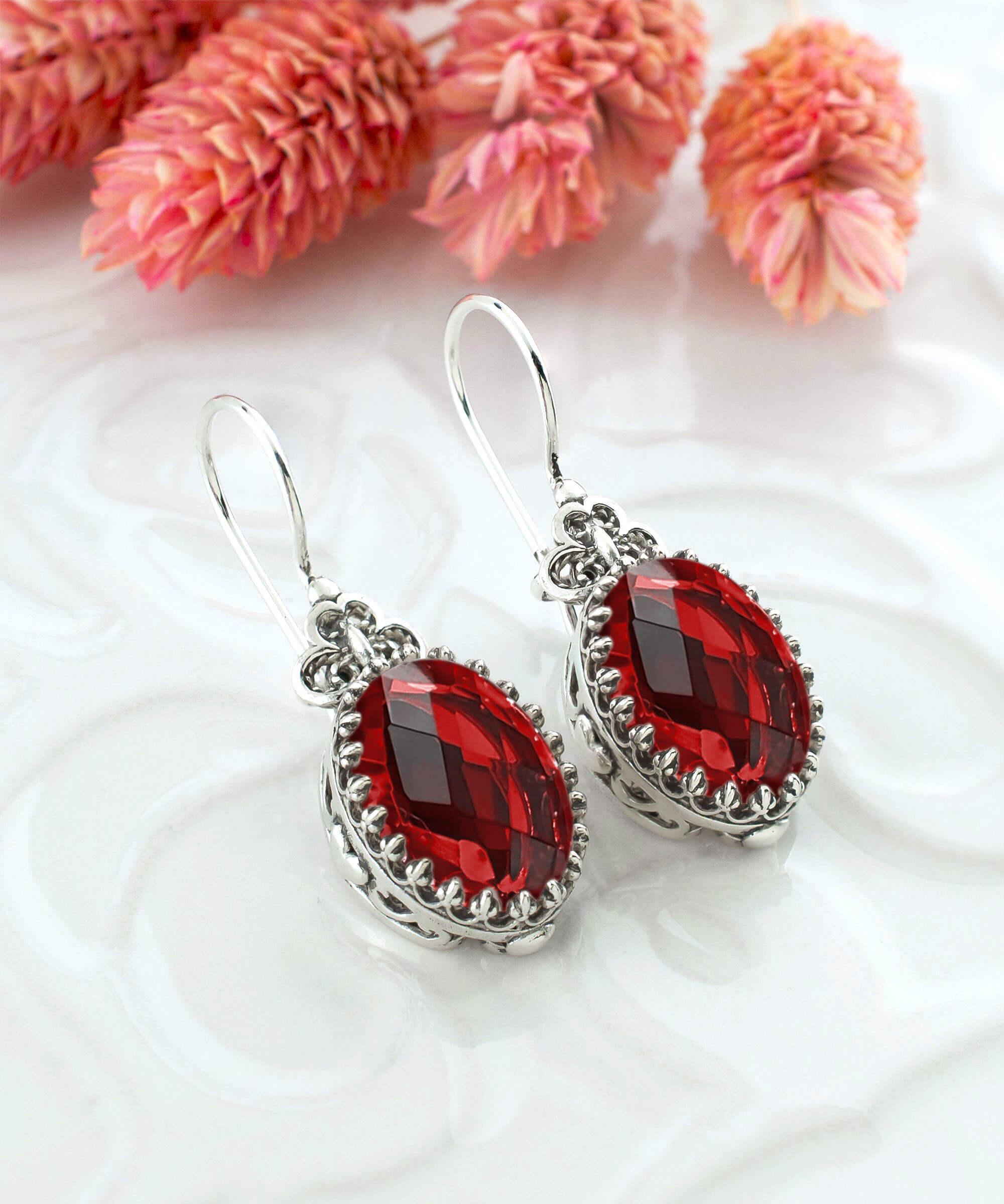 Elegant silver earrings featuring intricate filigree art and a vibrant Ruby Quartz gemstone in a heart design.