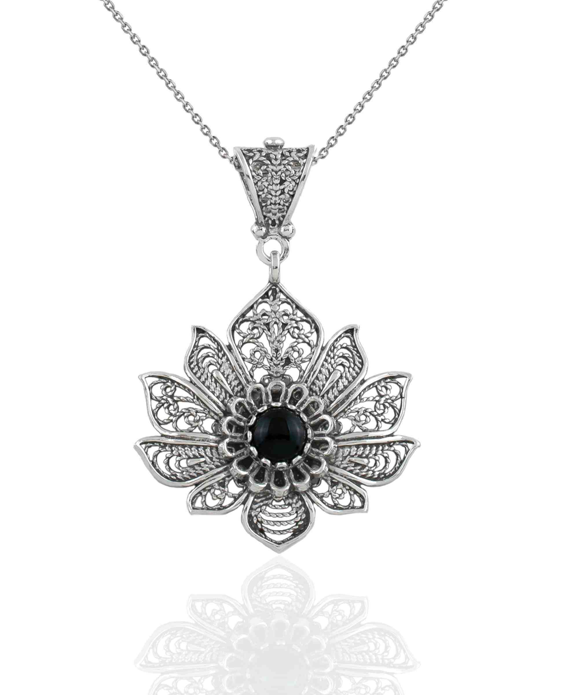 A handcrafted 925 Sterling Silver lotus flower pendant featuring a black onyx gemstone, showcasing intricate filigree art details.