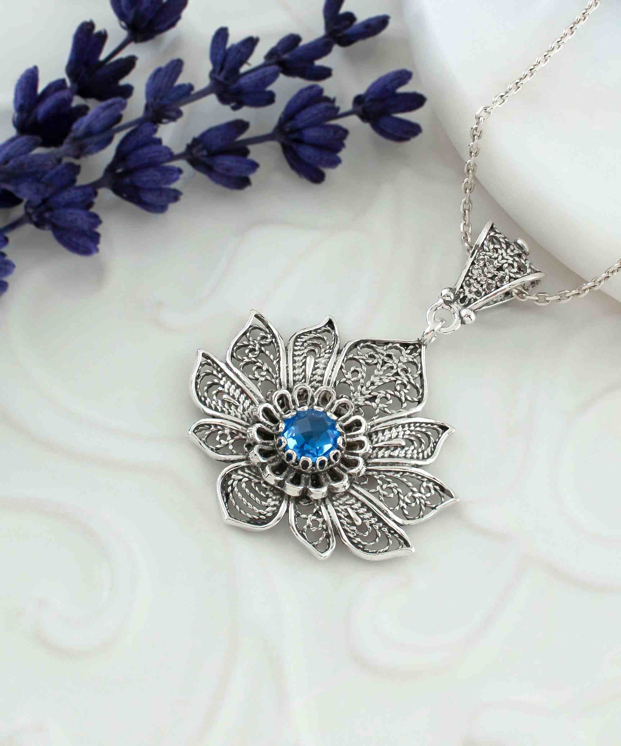 Handcrafted 925 Sterling Silver lotus flower pendant featuring a blue quartz gemstone, elegantly designed with intricate filigree art.