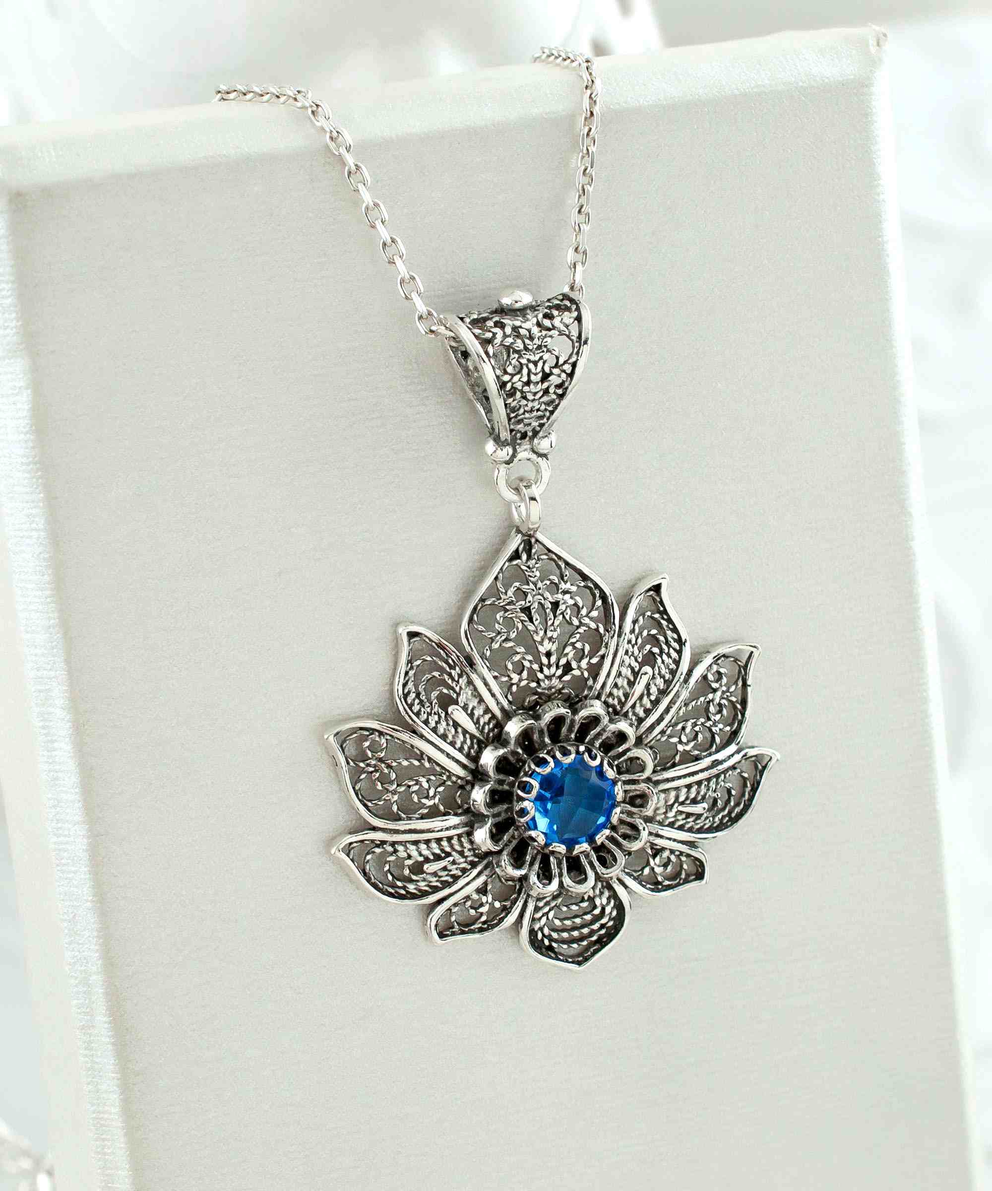 Handcrafted 925 Sterling Silver lotus flower pendant featuring a blue quartz gemstone, elegantly designed with intricate filigree art.