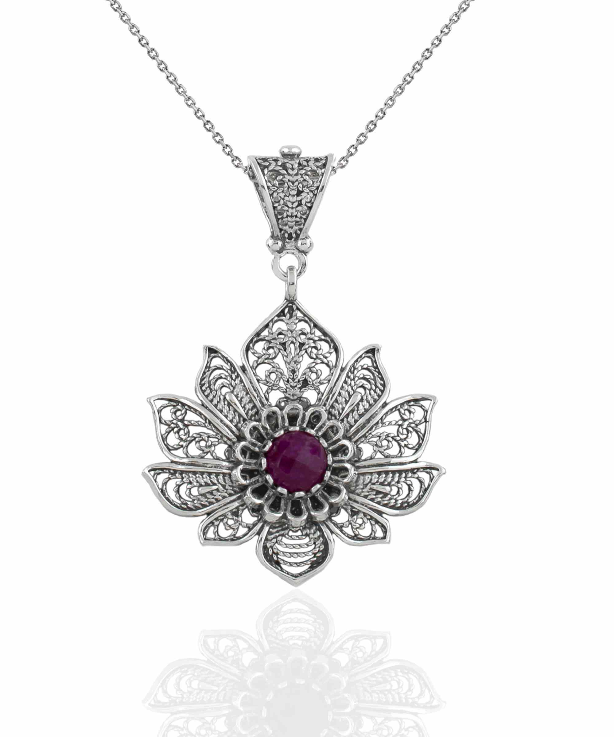 Handcrafted 925 Sterling Silver lotus flower pendant featuring a ruby corundum gemstone, elegantly designed with intricate filigree art.