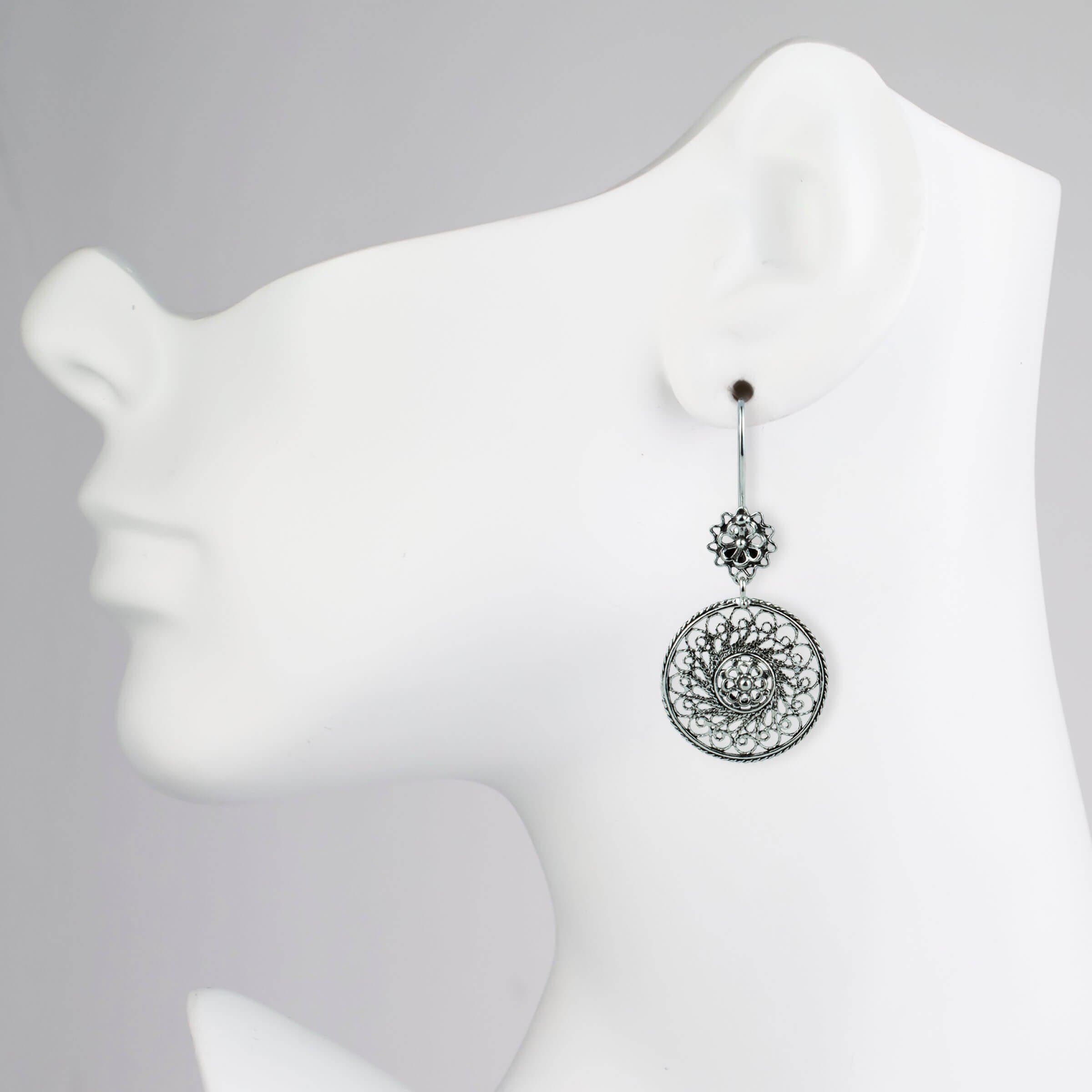 Elegant sterling silver dangle drop earrings featuring intricate filigree spiral flower design, showcasing antique and modern artistry.