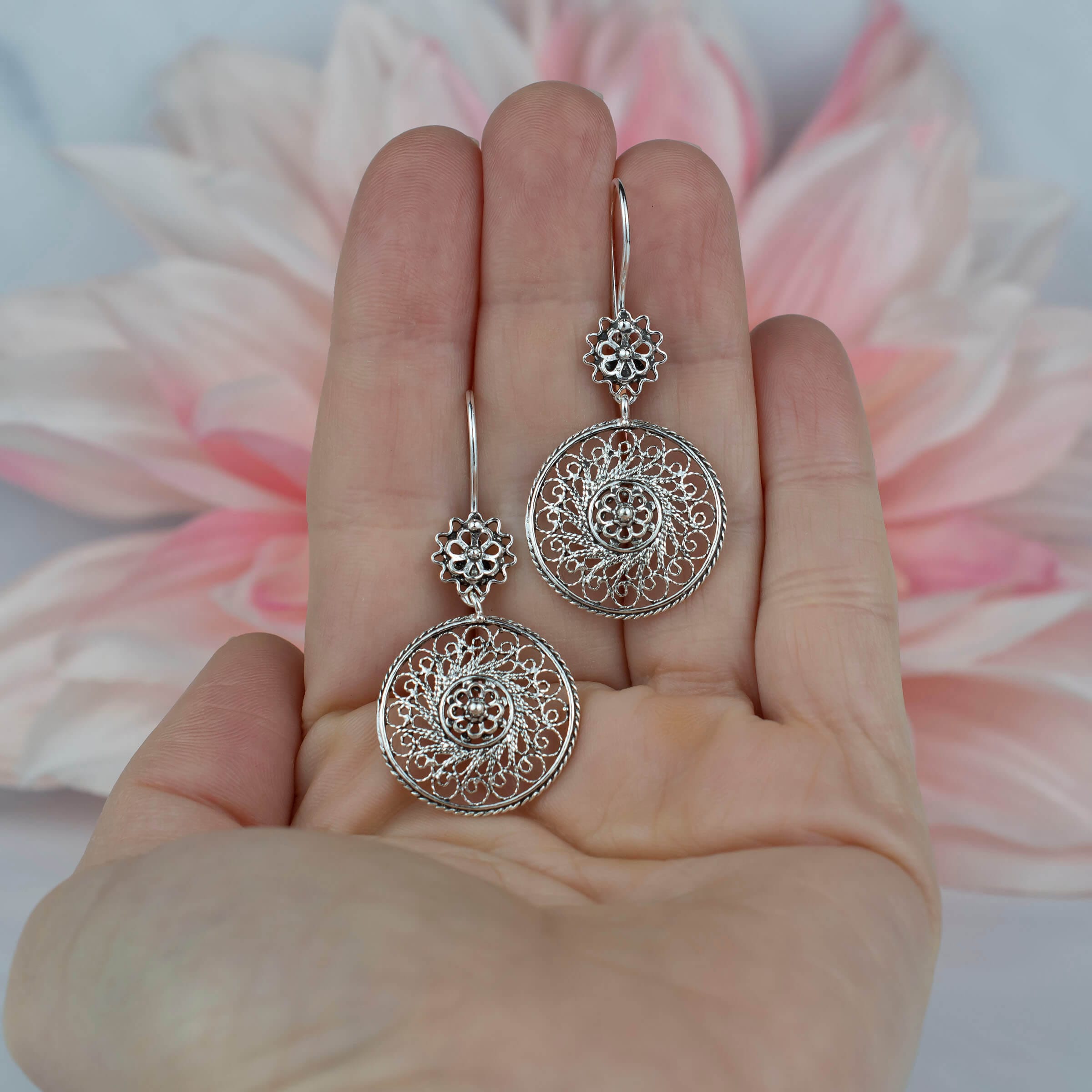 Elegant sterling silver dangle drop earrings featuring intricate filigree spiral flower design, showcasing antique and modern artistry.