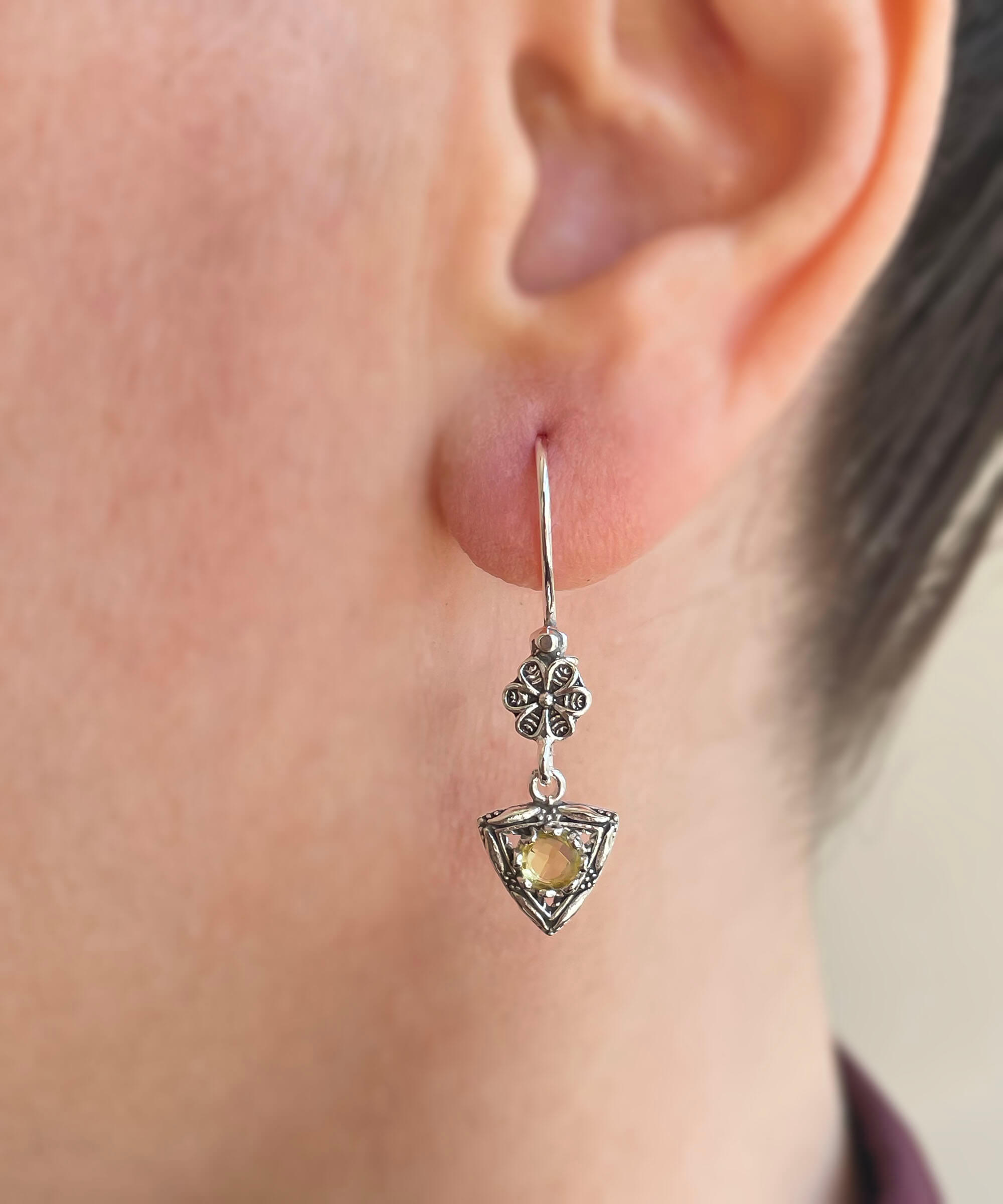 Elegant triangle-shaped silver dangle earrings featuring double-sided faceted gemstones in Amethyst, Blue Topaz, Blue Quartz, and Citrine.