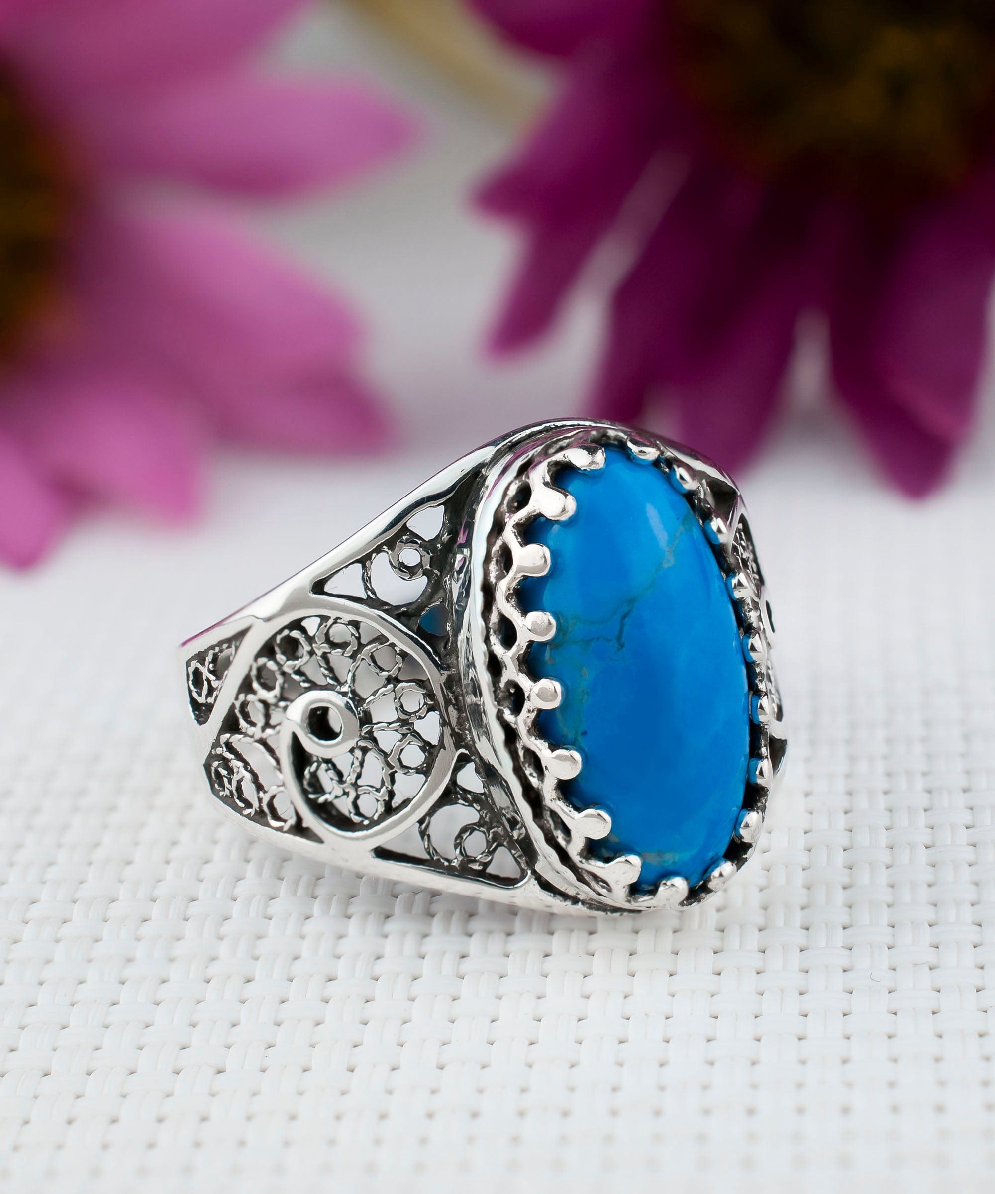 Elegant Filigree Art Turquoise Gemstone Oval Silver Cocktail Ring showcasing intricate metalwork and a vibrant turquoise stone.