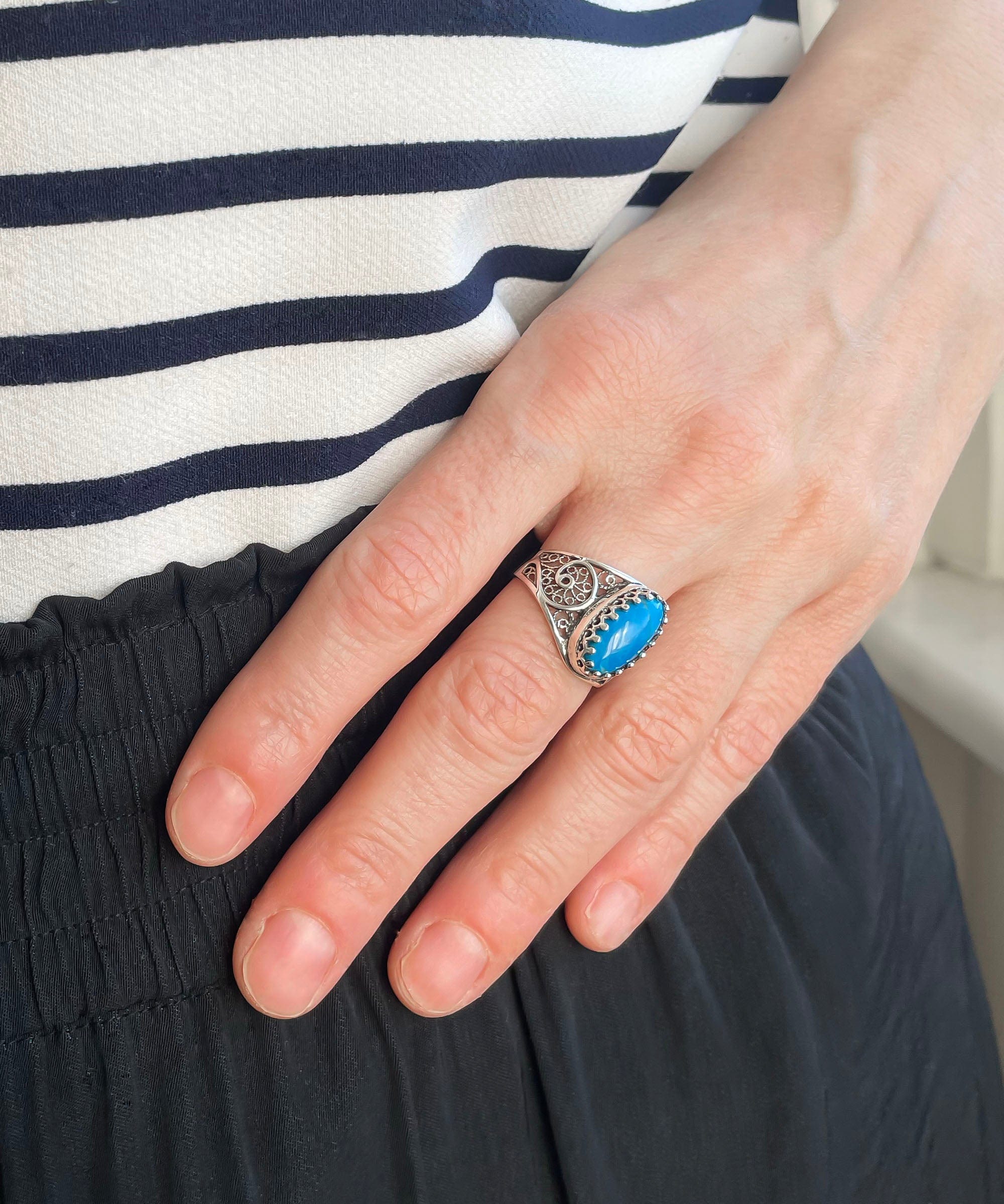 Elegant Filigree Art Turquoise Gemstone Oval Silver Cocktail Ring showcasing intricate metalwork and a vibrant turquoise stone.