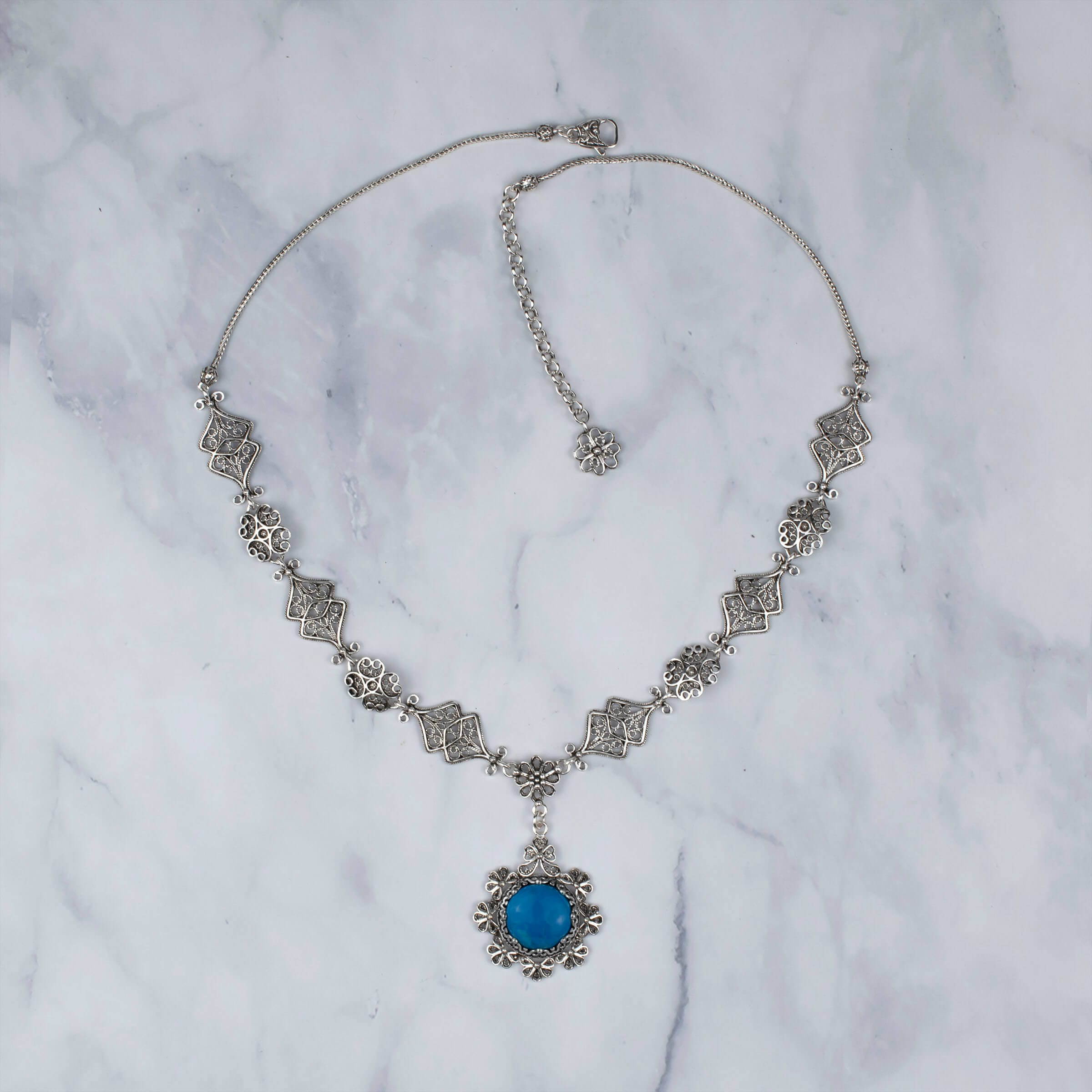 A stunning 925 sterling silver choker necklace featuring a turquoise gemstone in a delicate filigree design, perfect for women.