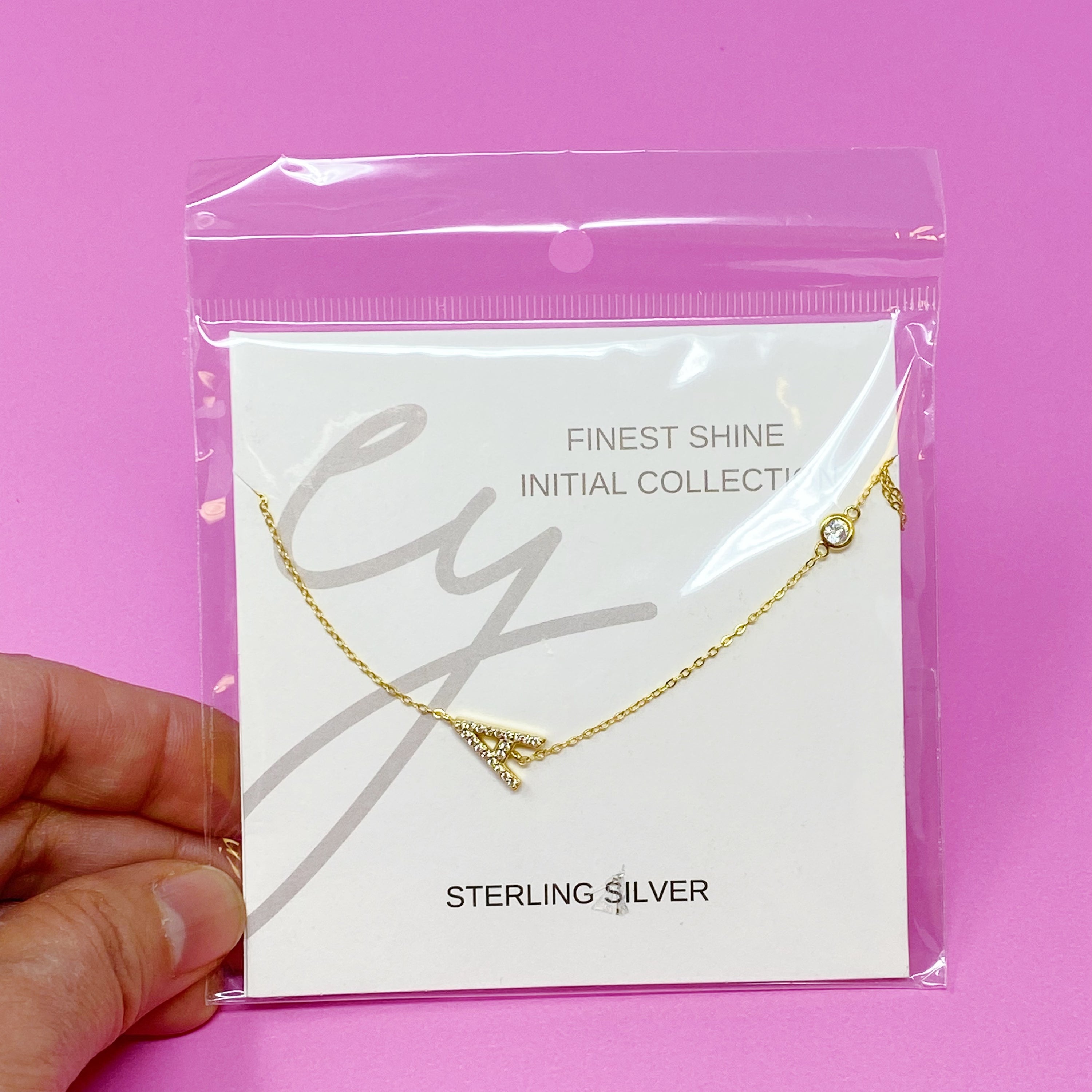 Finest Shine Initial Sterling Silver Necklace featuring a dainty chain, side hanging initial charm, and small cubic zirconia for added sparkle.